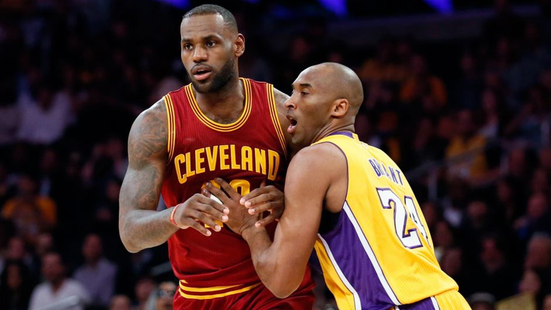 Cleveland Cavaliers' LeBron James, left, moves into position while Los Angeles Lakers' Kobe Bryant, right, defends during the first half of an NBA basketball game Thursday, March 10, 2016, in Los Angeles. (AP Photo/Danny Moloshok)