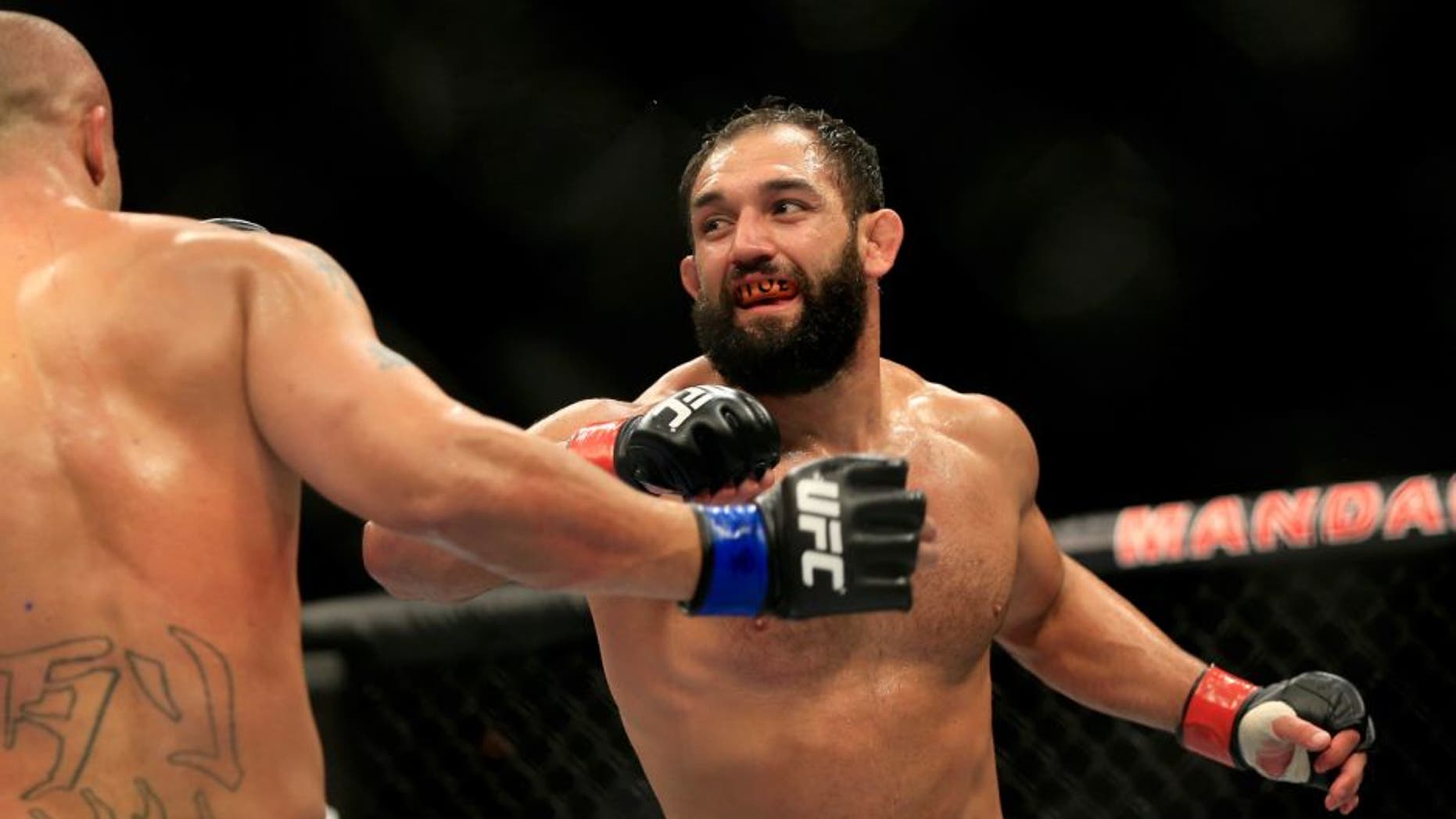 LAS VEGAS, NV - DECEMBER 06: Johny Hendricks punches Robbie Lawler in their welterweight title fight during the UFC 181 event at the Mandalay Bay Events Center on December 6, 2014 in Las Vegas, Nevada. (Photo by Alex Trautwig/Getty Images)