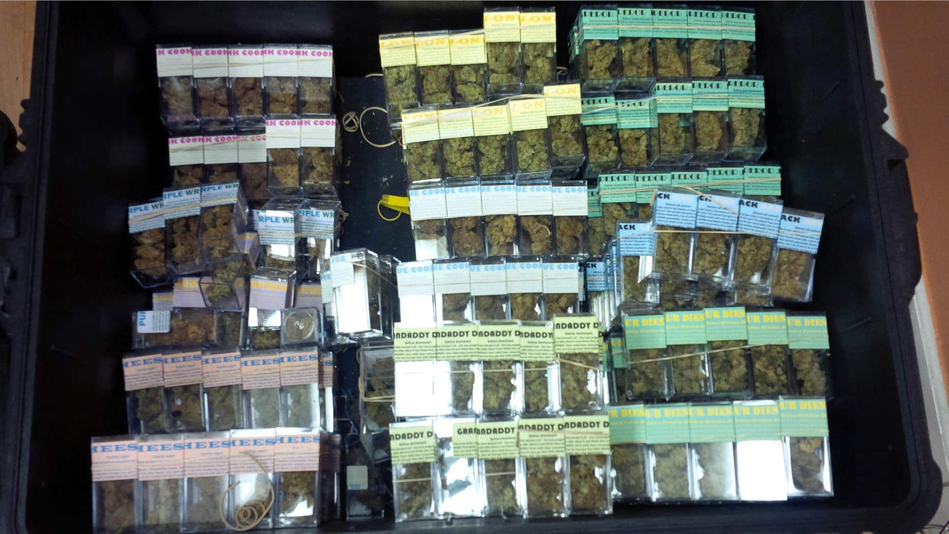 In this undated photo provided by the New York City Police Department, containers of packaged marijuana ready to be sold are shown inside a New York warehouse.