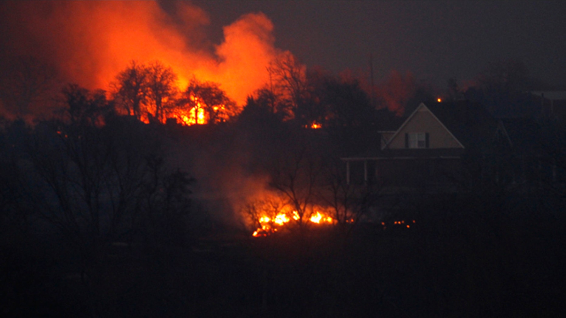 March 11: A grass fire burns near a home near Harrah, Okla.