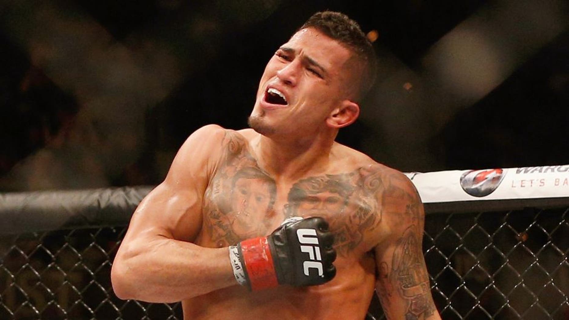 Anthony Pettis reacts to his victory over Gilbert Melendez in their UFC lightweight championship bout during the UFC 181 event inside the Mandalay Bay Events Center on December 6, 2014 in Las Vegas, Nevada. (Photo by Josh Hedges/Zuffa LLC/Zuffa LLC via Getty Images)