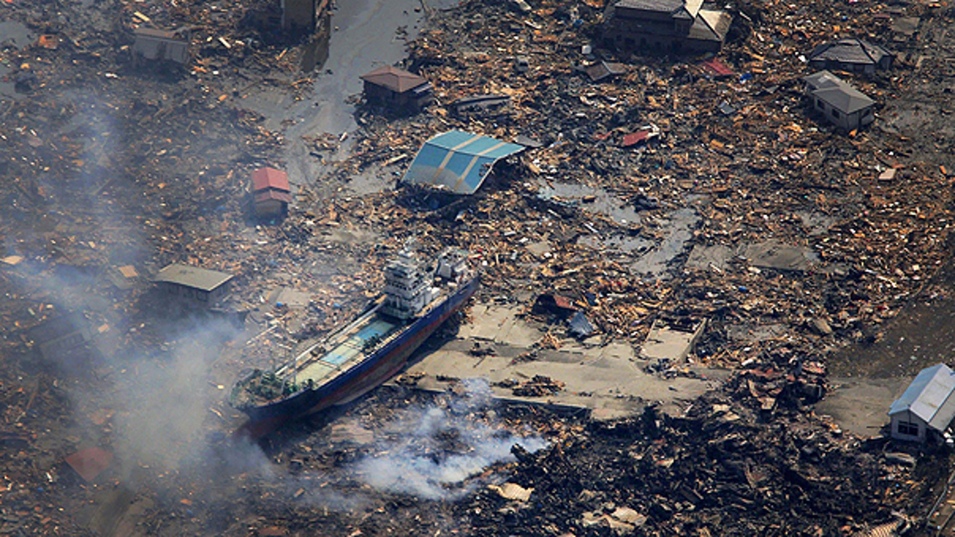 March 13: A ship washed away by tsunami sits amid debris in Kesennuma, Miyagi prefecture after Japan's biggest recorded earthquake hit its eastern coast Friday.