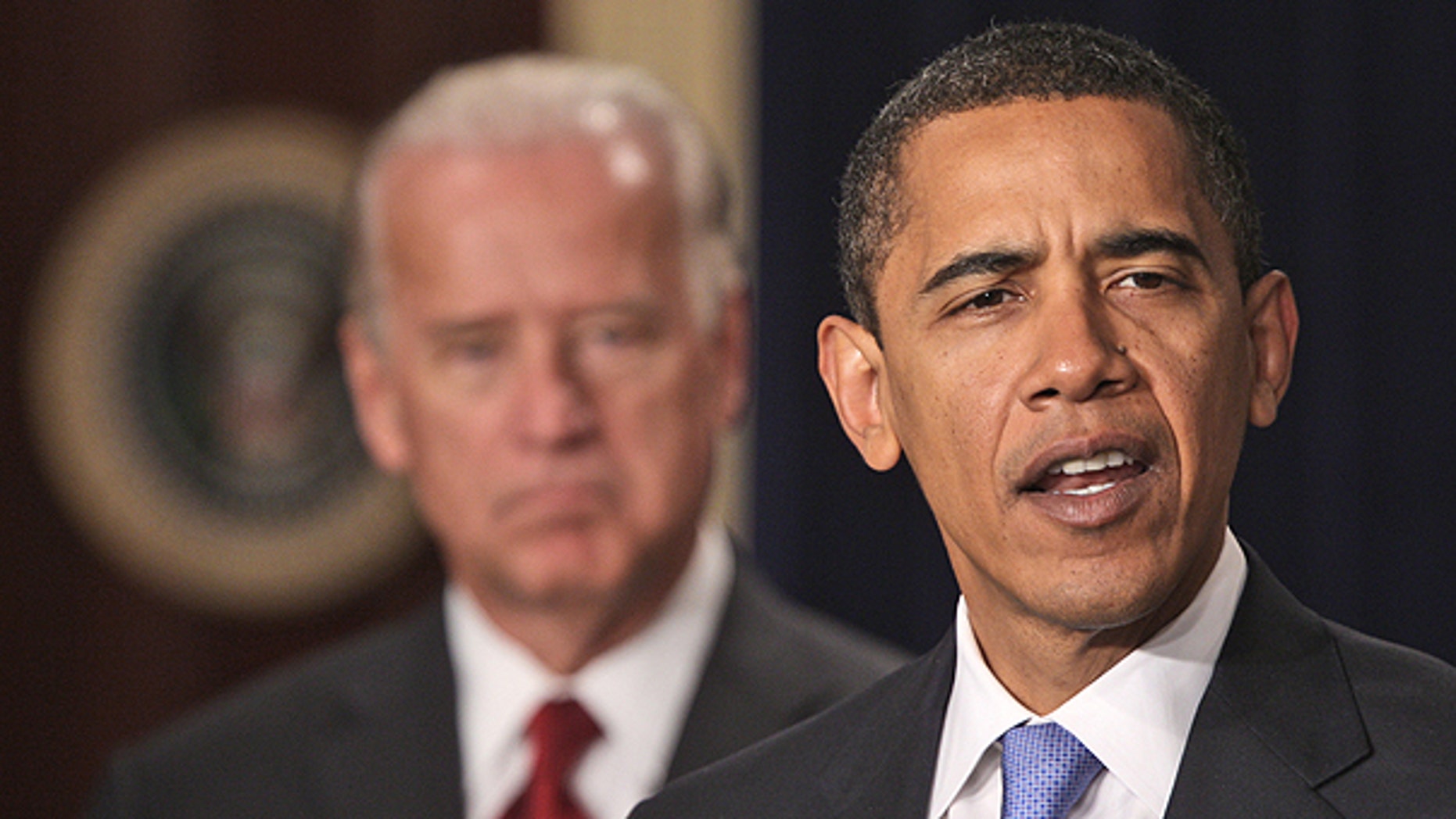 In this Jan. 21, 2009 file photo, President Barack Obama, accompanied by Vice President Joe Biden speaks in the Eisenhower Executive Office Building in Washington.