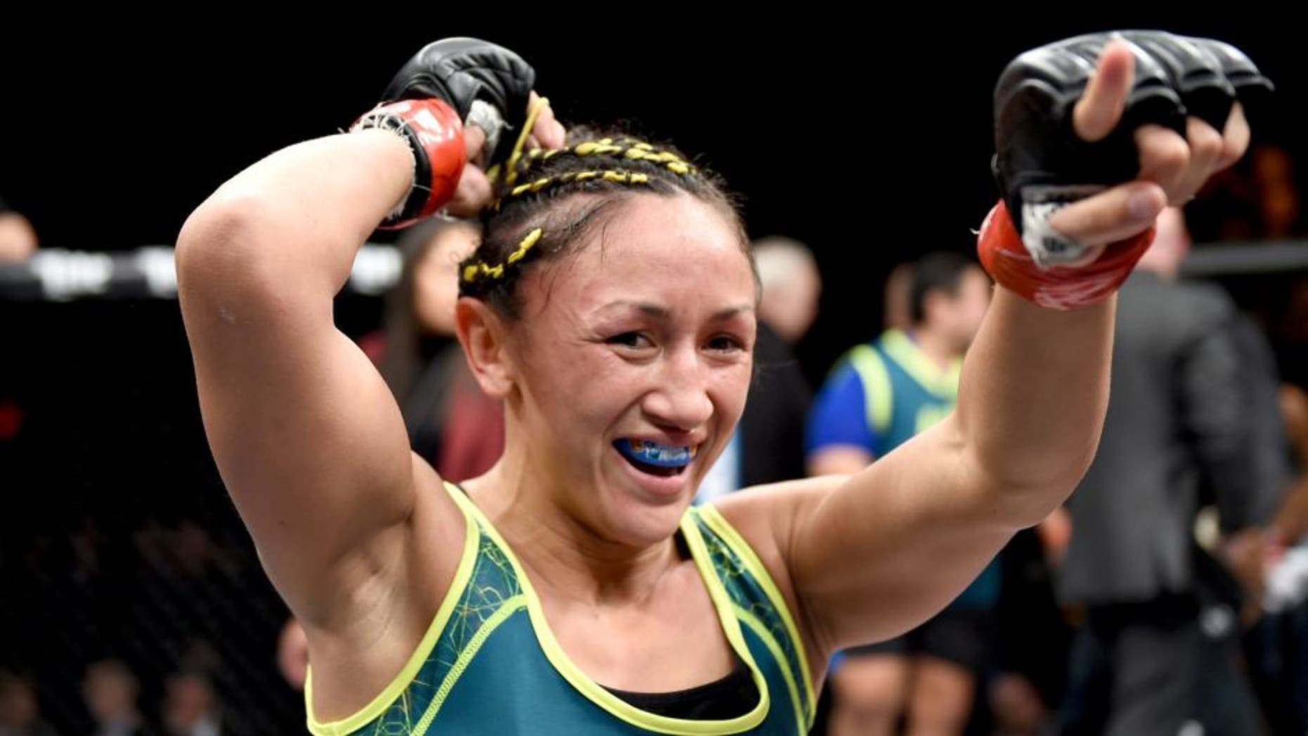 LAS VEGAS, NEVADA - DECEMBER 12: Carla Esparza celebrates her submission victory over Rose Namajunas in their strawweight championship fight during The Ultimate Fighter Finale event inside the Pearl concert theater at the Palms Casino Resort on December 12, 2014 in Las Vegas, Nevada. (Photo by Jeff Bottari/Zuffa LLC/Zuffa LLC via Getty Images)
