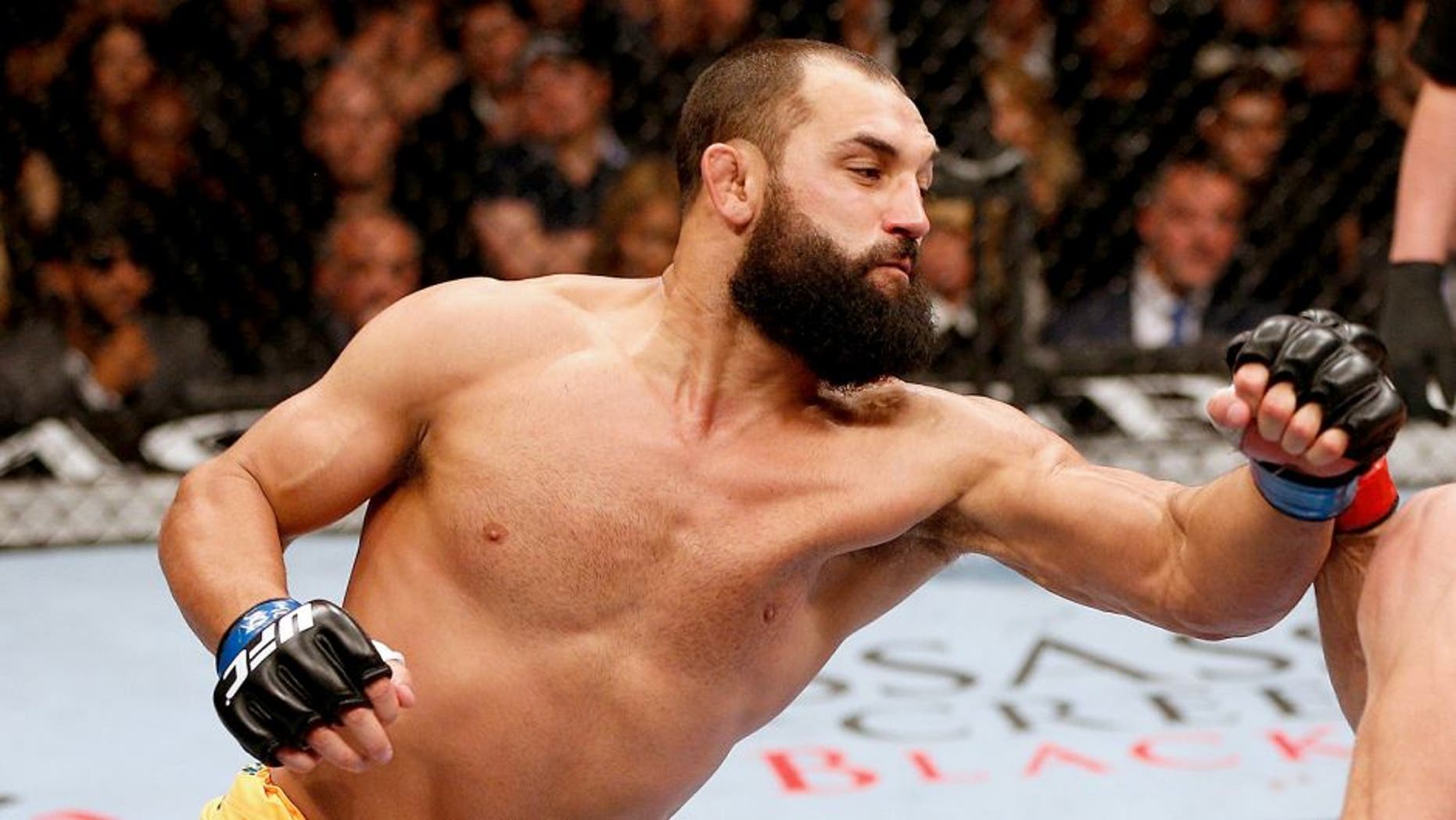 LAS VEGAS, NV - NOVEMBER 16: (L-R) Johny Hendricks punches Georges St-Pierre in their UFC welterweight championship bout during the UFC 167 event inside the MGM Grand Garden Arena on November 16, 2013 in Las Vegas, Nevada. (Photo by Josh Hedges/Zuffa LLC/Zuffa LLC via Getty Images)