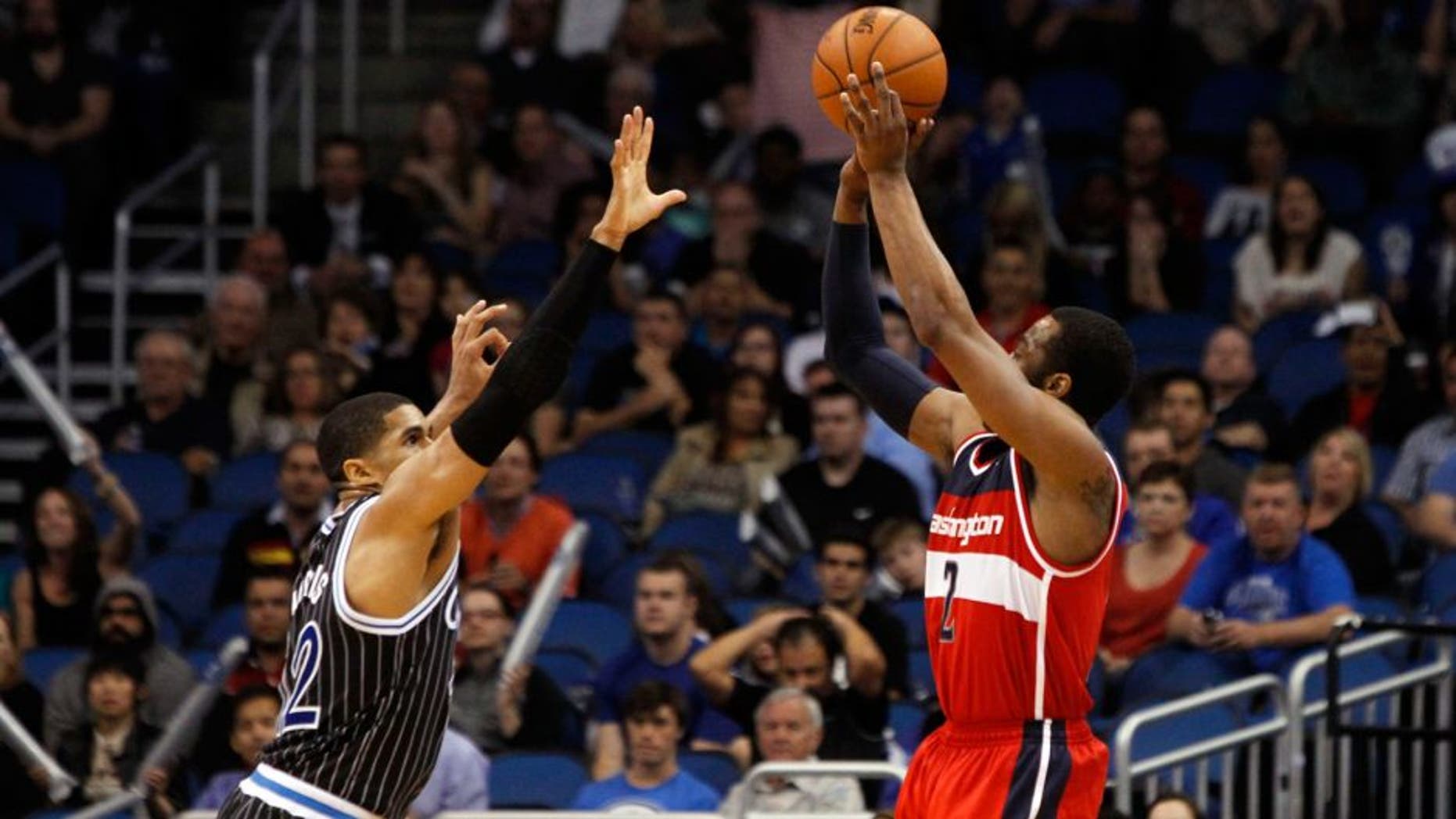 Mar 14, 2014; Orlando, FL, USA; Washington Wizards guard John Wall (2) shoots over Orlando Magic forward Tobias Harris (12) to tie the game and force it into overtime during the fourth quarter at Amway Center. Washington Wizards defeated the Orlando Magic 105-101. Mandatory Credit: Kim Klement-USA TODAY Sports
