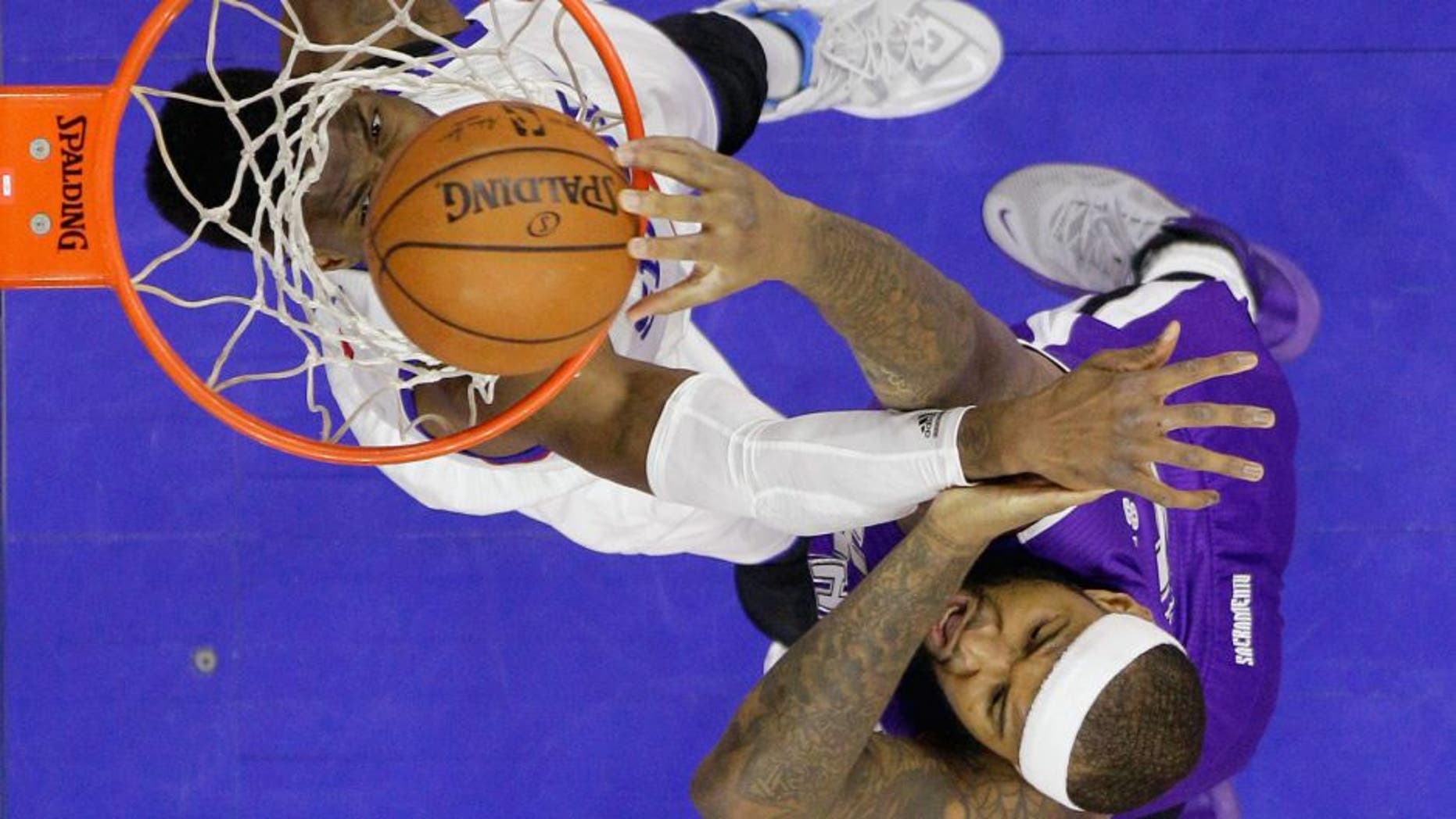 Sacramento Kings' DeMarcus Cousins, right, dunks the ball against Philadelphia 76ers' Nerlens Noel during the first half of an NBA basketball game, Friday, March 13, 2015, in Philadelphia. (AP Photo/Matt Slocum)