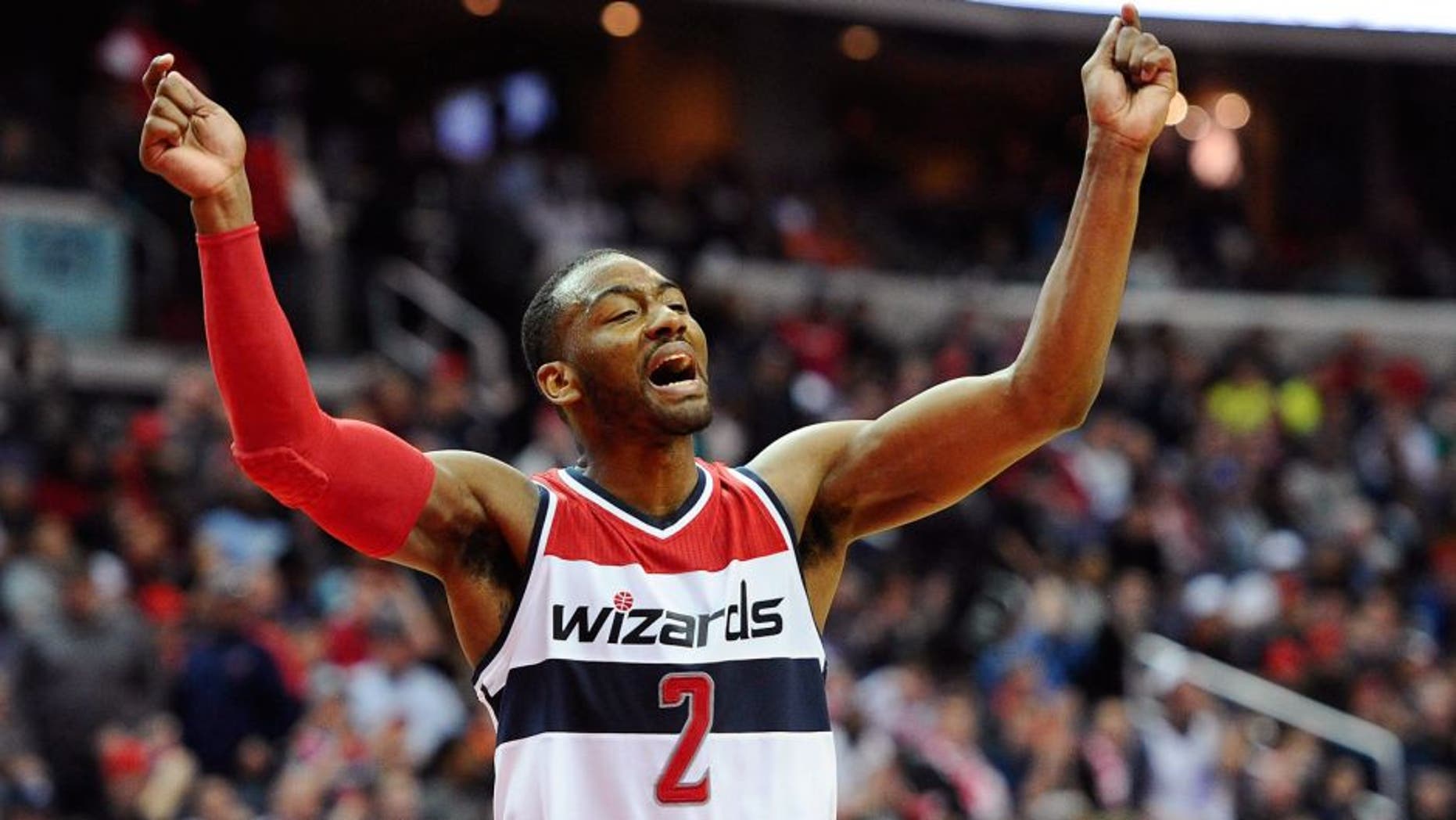 Mar 14, 2015; Washington, DC, USA; Washington Wizards guard John Wall (2) celebrates against the Sacramento Kings during the fourth quarter at Verizon Center. Mandatory Credit: Brad Mills-USA TODAY Sports