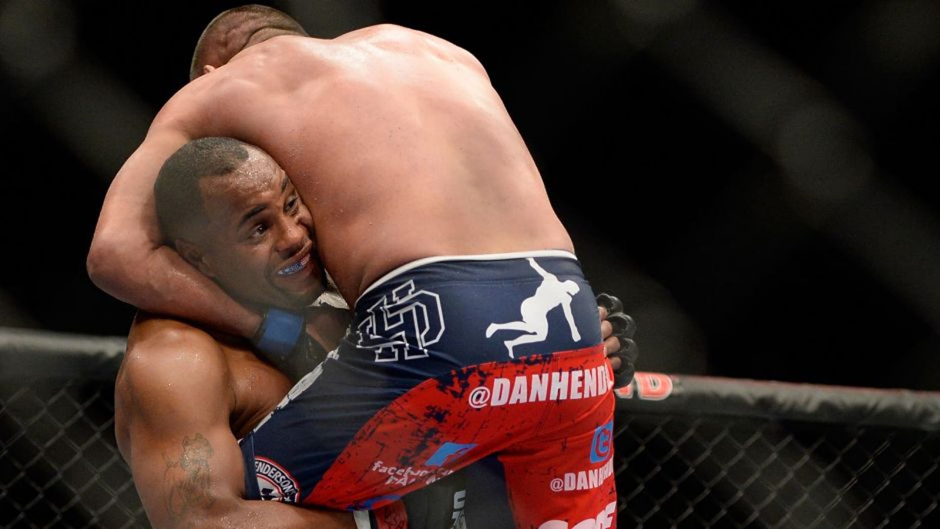 LAS VEGAS, NV - MAY 24: (L-R) Daniel Cormier throws down Dan Henderson in their light heavyweight bout during the UFC 173 event at the MGM Grand Garden Arena on May 24, 2014 in Las Vegas, Nevada. (Photo by Jeff Bottari/Zuffa LLC/Zuffa LLC via Getty Images)