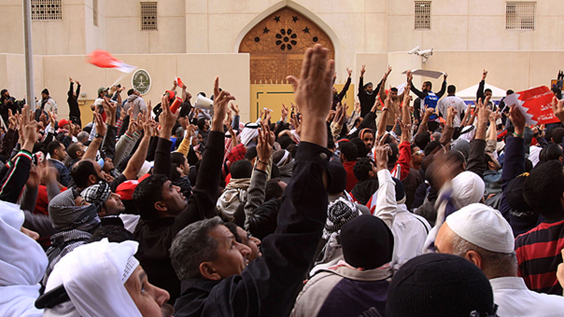 March 15: Anti-government protesters gesture in front of the Saudi embassy in Manama, Bahrain.