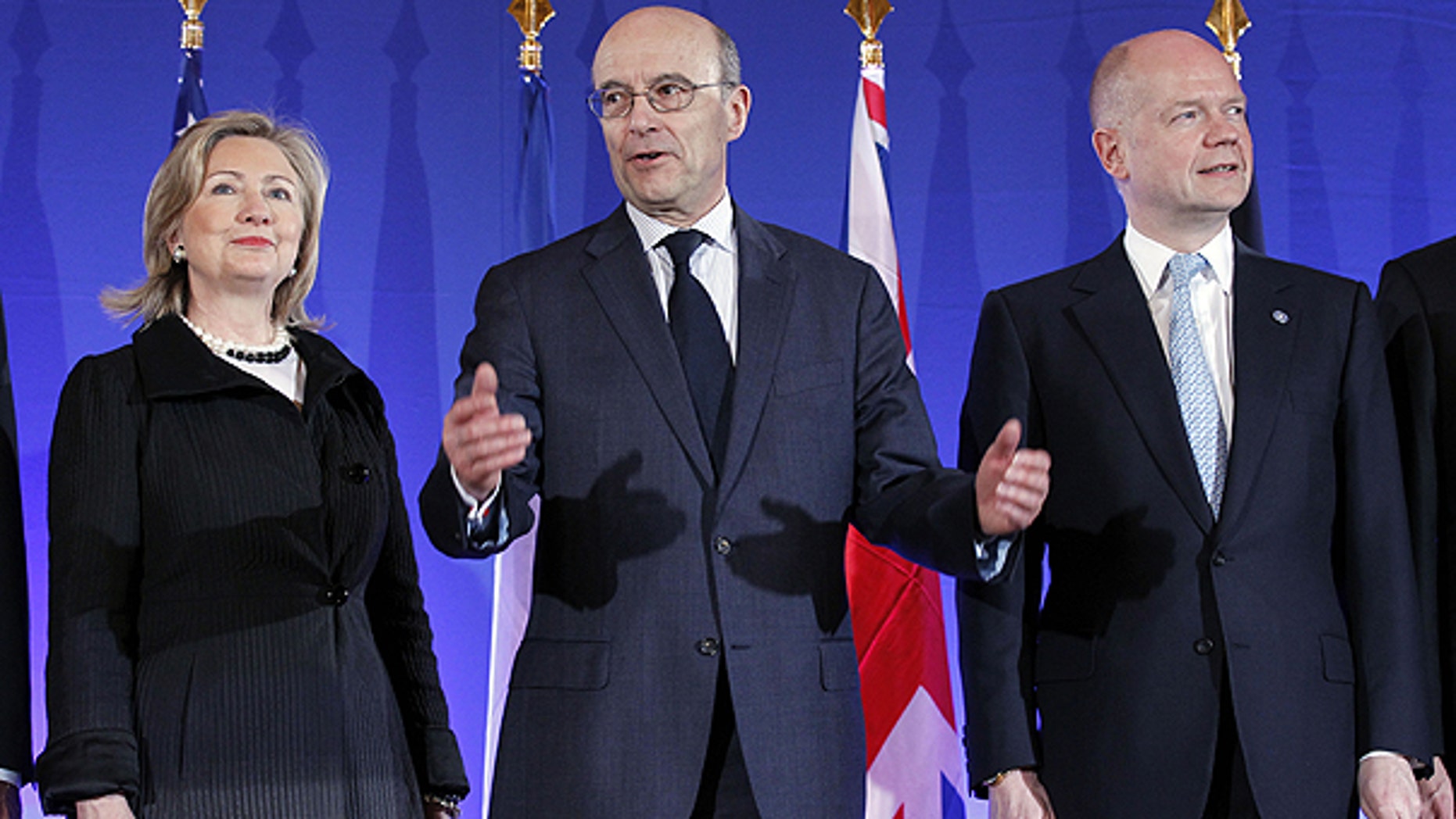 March 14: French Foreign Minister Alain Juppe, center, gestures as he poses with his counterpart William Hague of Britain and U.S. Secretary of State Hillary Rodham Clinton, during a Group of Eight foreign Ministers meeting in Paris.
