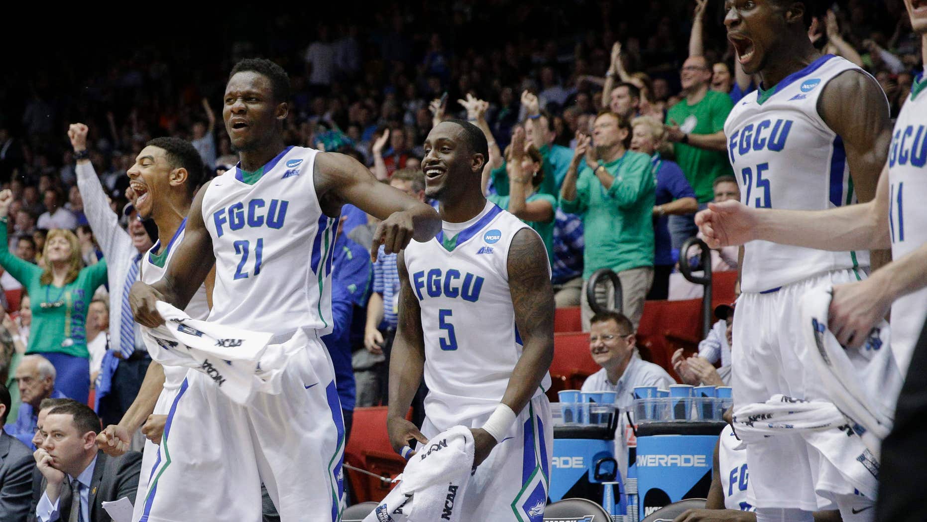 Florida Gulf Coast's Demetris Morant (21), Zach Johnson (5), and Marc Eddy Norelia (25) react after Brian Greene Jr., not pictured, dunks in the second half of a First Four game of the NCAA college basketball tournament against Fairleigh Dickinson, Tuesday, March 15, 2016, in Dayton, Ohio.
