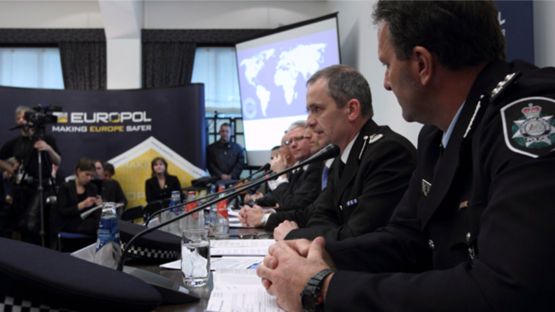 March 16: From left, Grant Edwards, Australian Federal Police, and Peter Davies, of the UK Child Exploitation and Online Protection Center, elaborate on the details of arrests linked to a global child abuse ring during a press conference in The Hague.