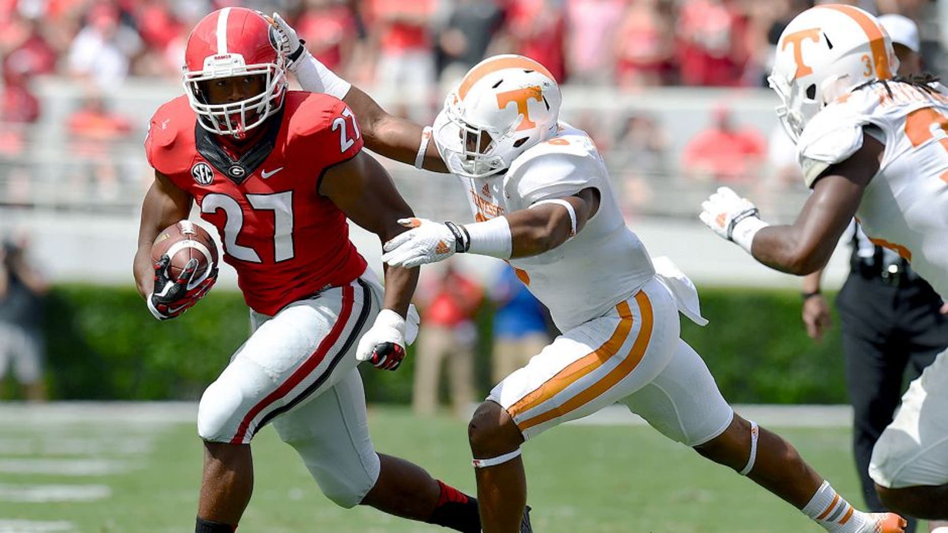 Sep 27, 2014; Athens, GA, USA; Georgia Bulldogs running back Nick Chubb (27) runs against Tennessee Volunteers defensive back Todd Kelly Jr. (6) during the first half at Sanford Stadium. Mandatory Credit: Dale Zanine-USA TODAY Sports