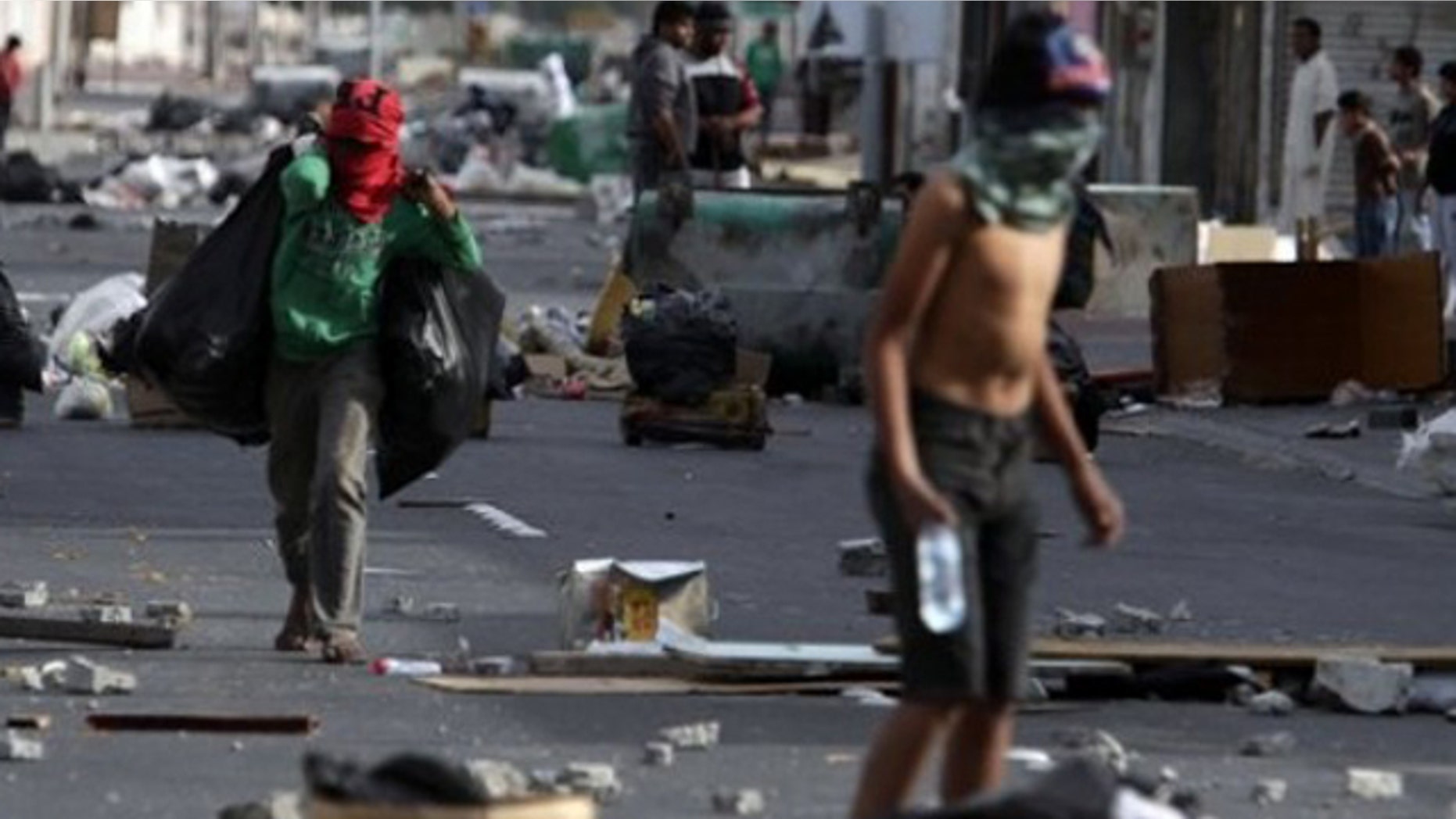 March 16: Shiite Bahraini youths haul debris into the streets of the western village of Malkiya, Bahrain, in preparation for government-supporting forces they anticipate will roll into their Shiite Muslim village southwest of the capital of Manama.