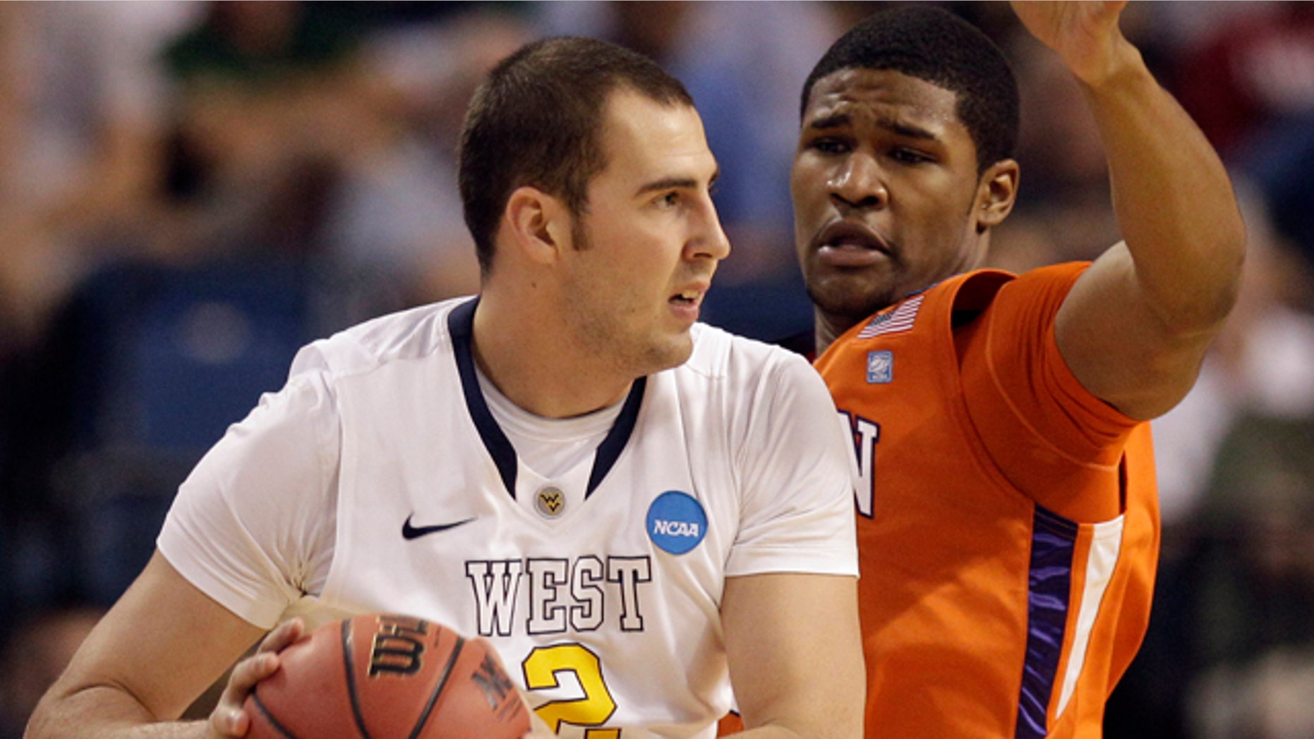 March 17: Clemson's Devin Booker (31) defends as West Virginia's Cam Thoroughman (2) attempts to pass during an East regional second round NCAA tournament college basketball game in Tampa, Fla.