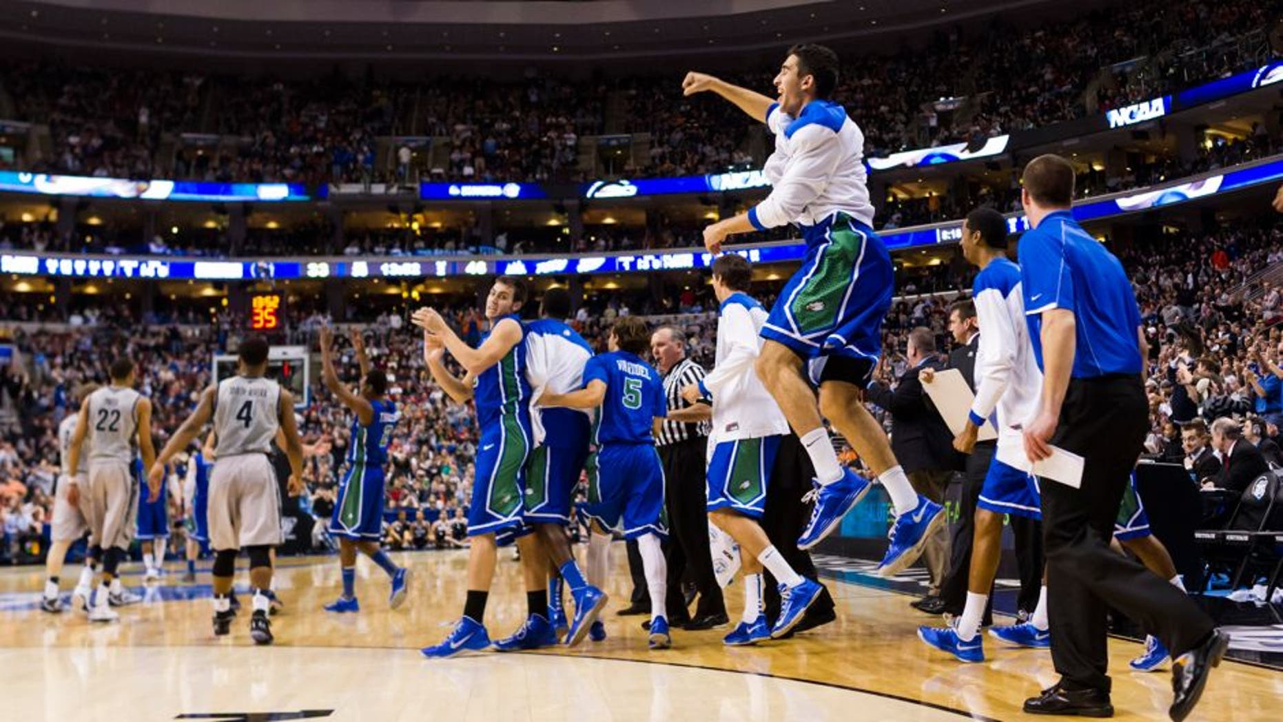 Mar 22, 2013; Philadelphia, PA, USA; Florida Gulf Coast Eagles players celebrate ;ate in the second half against the Georgetown Hoyas during the second round of the 2013 NCAA tournament at the Wells Fargo Center. Florida Gulf Coast defeated Georgetown 78-68. Mandatory Credit: Howard Smith-USA TODAY Sports