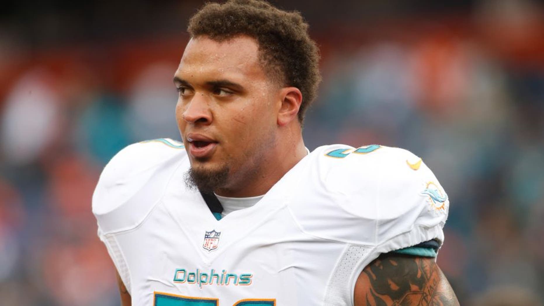 Nov 23, 2014; Denver, CO, USA; Miami Dolphins guard Mike Pouncey (51) before the game against the Denver Broncos at Sports Authority Field at Mile High. Mandatory Credit: Chris Humphreys-USA TODAY Sports