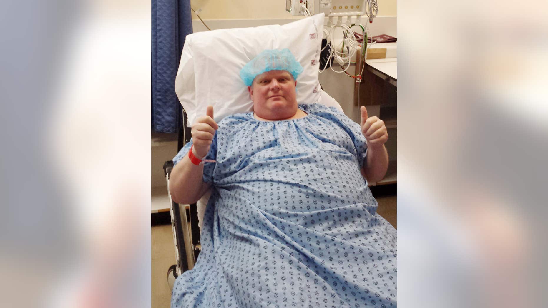 FILE - In this Monday, May 11, 2015 photo provided by Dan Jacobs, former Toronto Mayor Rob Ford gives a thumbs up before surgery in Toronto, to remove a cancerous tumor from his abdomen.