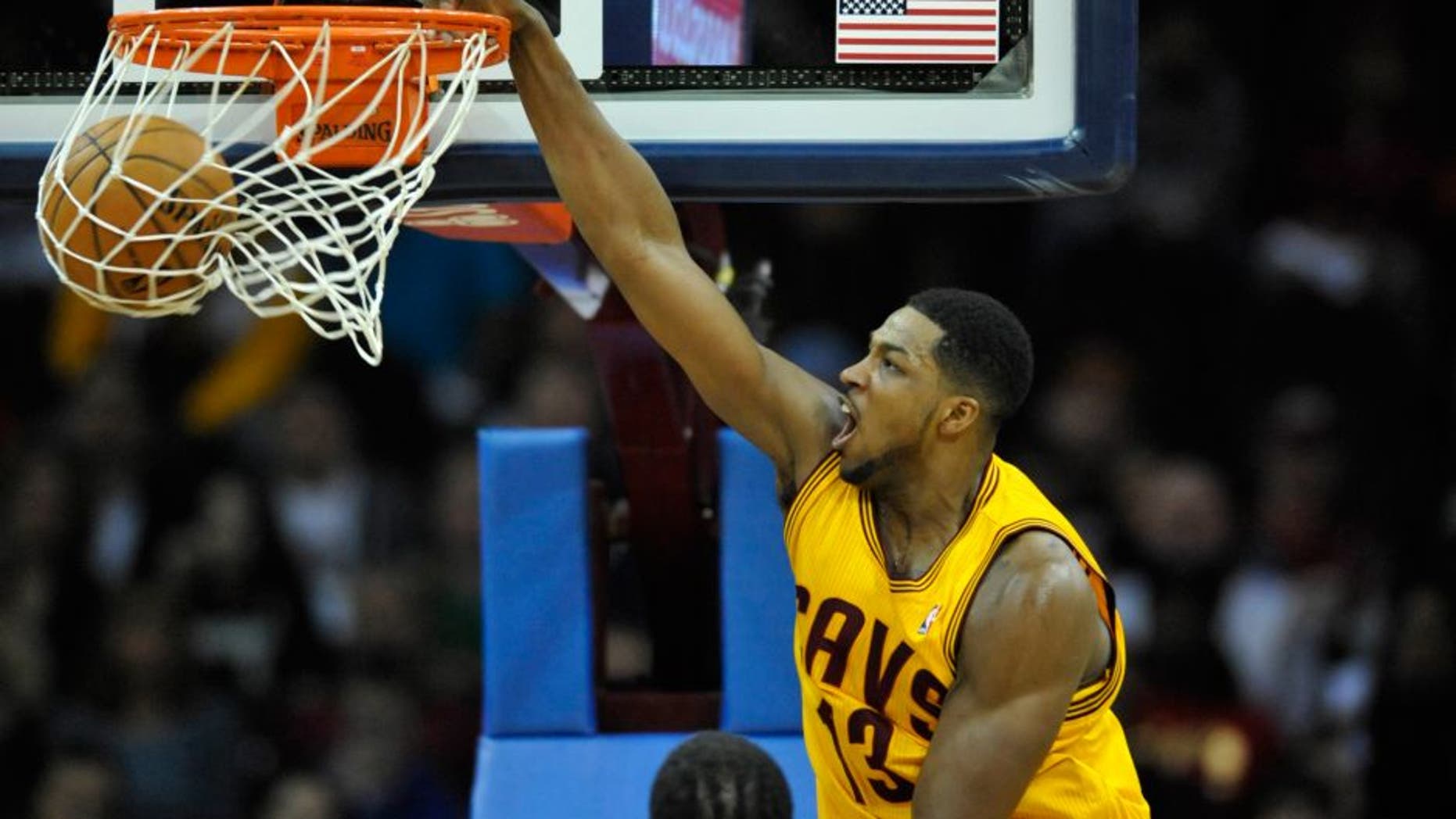Mar 18, 2014; Cleveland, OH, USA; Cleveland Cavaliers forward Tristan Thompson (13) dunks against the Miami Heat in the first quarter at Quicken Loans Arena. Mandatory Credit: David Richard-USA TODAY Sports