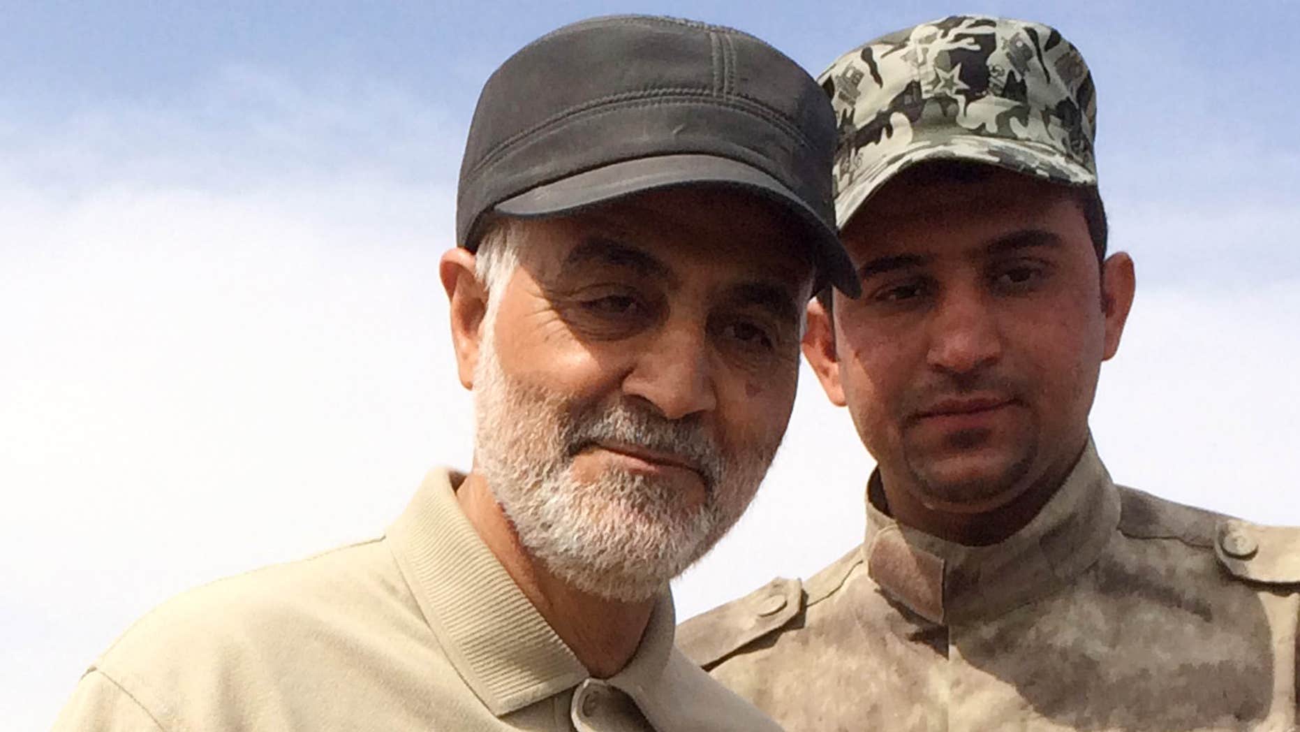 March 8, 2015: Iranian Revolutionary Guard Commander Qassem Soleimani (L) stands at the frontline during offensive operations against Islamic State militants in the town of Tal Ksaiba in Salahuddin province.