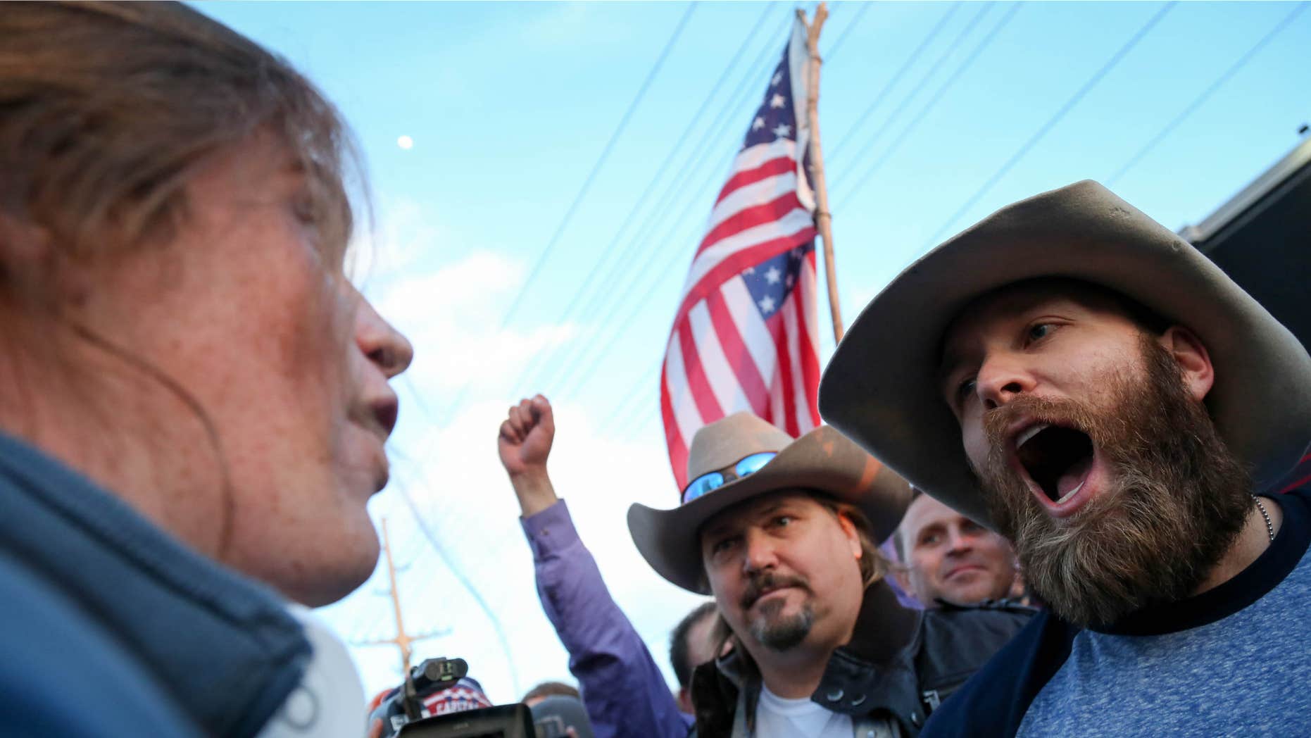 March 18, 2016: A protester confronts supporters of Republican presidential candidate Donald Trump in downtown Salt Lake City as Donald Trump gave his first campaign speech in Utah.