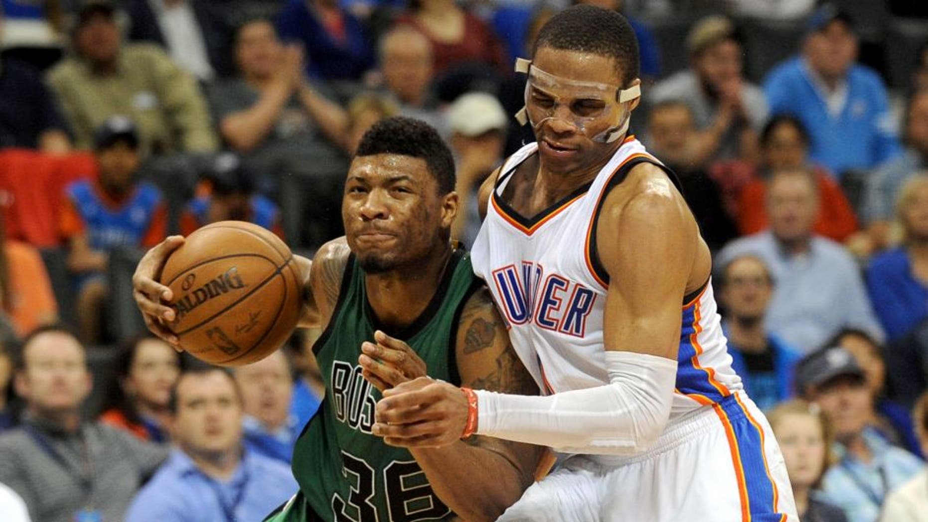Mar 18, 2015; Oklahoma City, OK, USA; Boston Celtics guard Marcus Smart (36) drives to the basket after colliding with Oklahoma City Thunder guard Russell Westbrook (0) during the fourth quarter at Chesapeake Energy Arena. Mandatory Credit: Mark D. Smith-USA TODAY Sports
