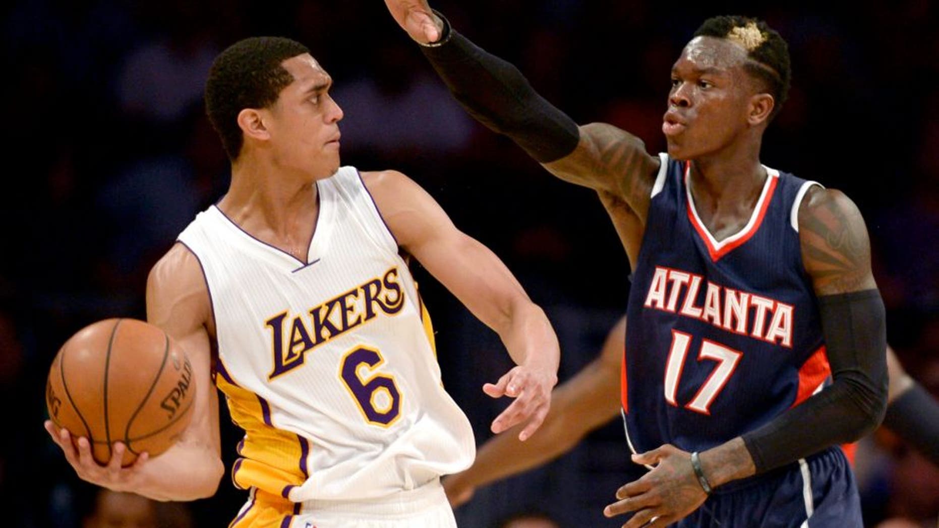 Mar 15, 2015; Los Angeles, CA, USA; Los Angeles Lakers guard Jordan Clarkson (6) looks to pass the ball defended by Atlanta Hawks guard Dennis Schroder (17) during the fourth quarter at Staples Center. The Atlanta Hawks won 91-86. Mandatory Credit: Kelvin Kuo-USA TODAY Sports