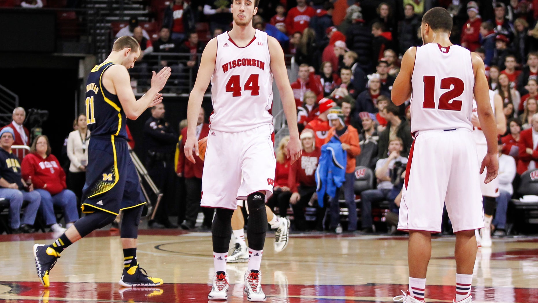 Wisconsin's Frank Kaminsky (44) and Traevon Jackson (12) walk off the court after the team's 77-70 loss to Michigan in an NCAA college basketball game Saturday, Jan. 18, 2014, in Madison, Wis. (AP Photo/Andy Manis)