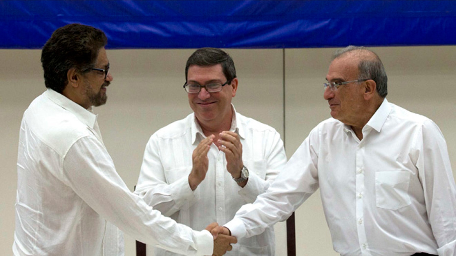 Humberto de La Calle, Ivan Marquez and Cuban Foreign Minister Bruno Rodriguez after signing an agreement in Havana, Cuba.