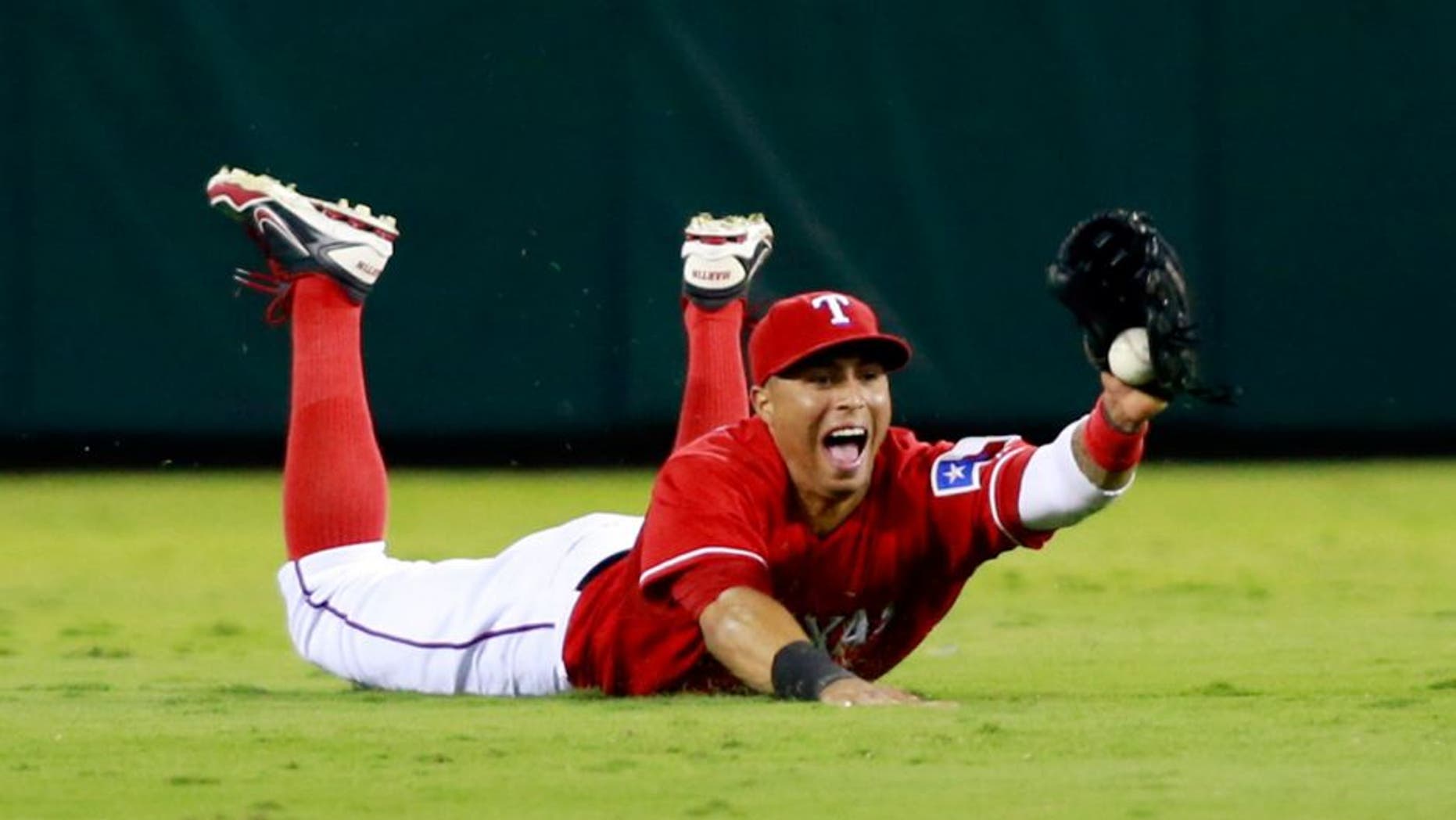 Sep 30, 2013; Arlington, TX, USA; Texas Rangers center fielder Leonys Martin catches a ball hit by Tampa Bay Rays designated hitter Delmon Young (not pictured) during the seventh inning at Rangers Ballpark at Arlington. Mandatory Credit: Tim Heitman-USA TODAY Sports