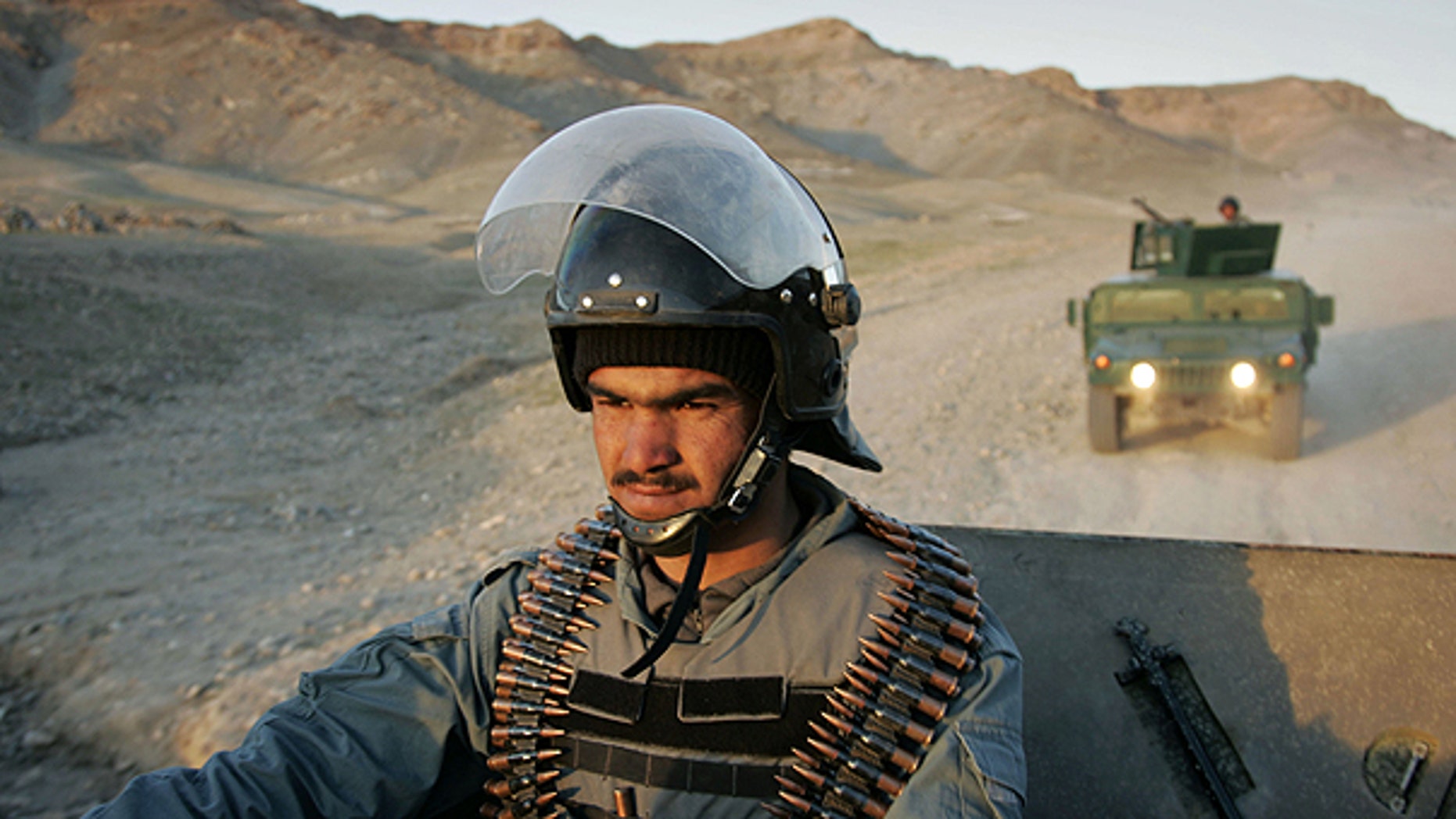 March 19: An Afghan policeman controls the area during a patrol in Guzara district, Herat province east of Kabul, Afghanistan.