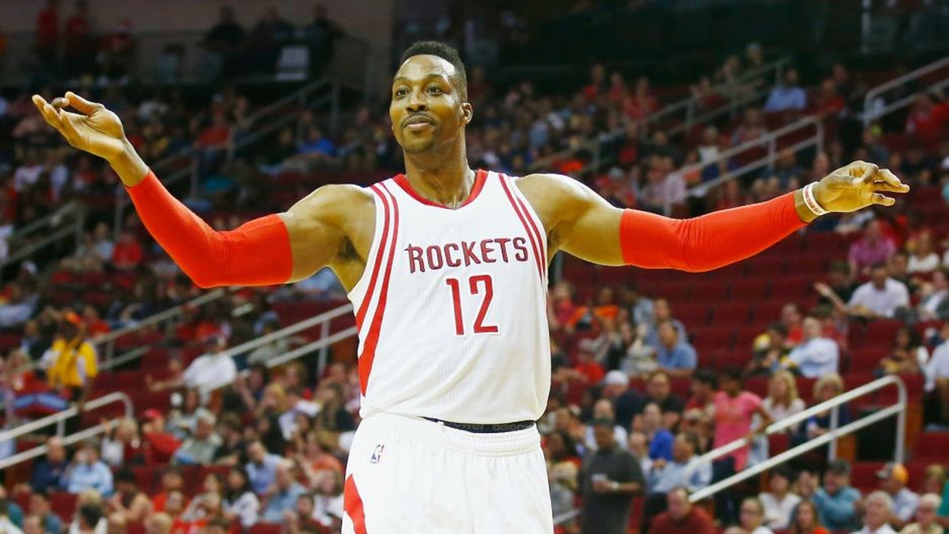 Dwight Howard #12 of the Houston Rockets battles for a rebound with Gorgui Dieng #5 of the Minnesota Timberwolves during their game at the Toyota Center on March 18, 2016 in Houston, Texas. NOTE TO USER: User expressly acknowledges and agrees that, by downloading and or using this Photograph, user is consenting to the terms and conditions of the Getty Images License Agreement. *** Local Caption *** Dwight Howard; Gorgui Dieng