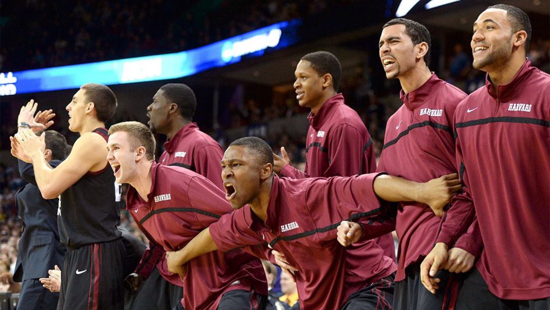 Mar 22, 2014; Spokane, WA, USA; Harvard Crimson players celebrate against the Michigan State Spartans in the second half of a men's college basketball game during the third round of the 2014 NCAA Tournament at Veterans Memorial Arena. Mandatory Credit: Kirby Lee-USA TODAY Sports