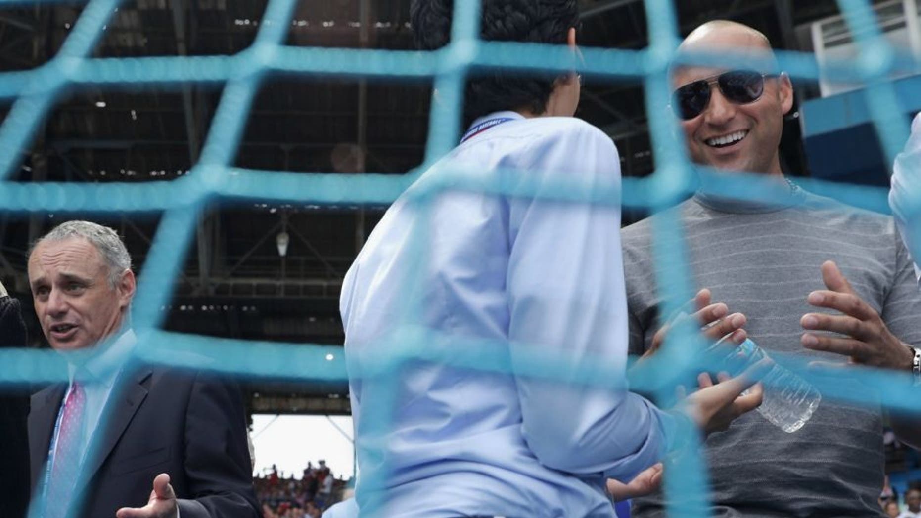 Major League Baseball Commissioner Rob Manfred (L) and former player Derek Jeter (R) visit with friends before an exhibition baseball game between the Cuban national baseball team and the Major League Baseball team Tampa Bay Devil Rays at the Estado Latinoamericano March 22, 2016 in Havana, Cuba. Cuban President Raul Castro and U.S. President Barack Obama attended the game, the first time a sittng president has visited Cuba in 88 years. (Photo by Chip Somodevilla/Getty Images)