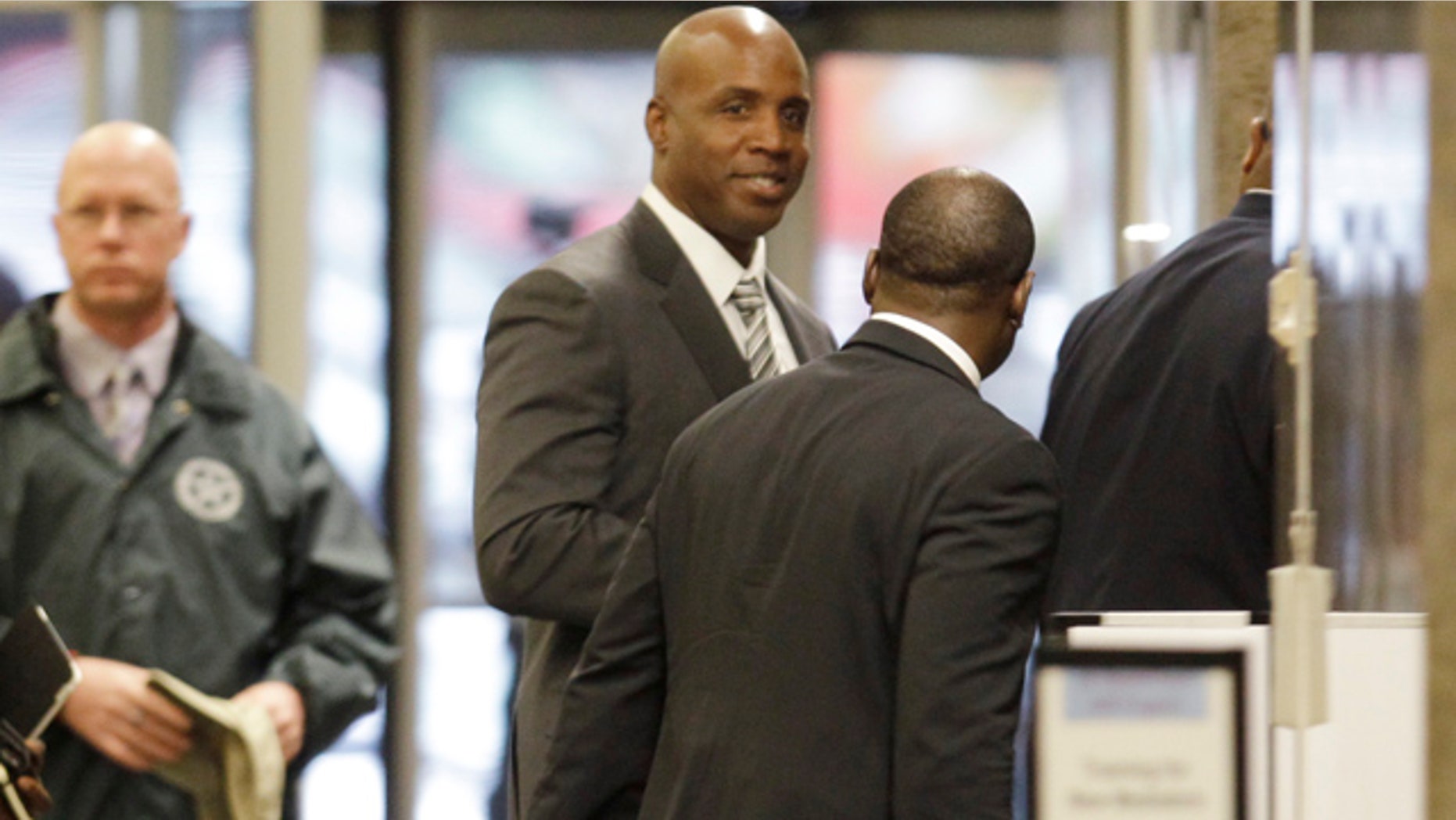 March 23: Barry Bonds goes through security as he arrives at the federal courthouse for his criminal trial in San Francisco.