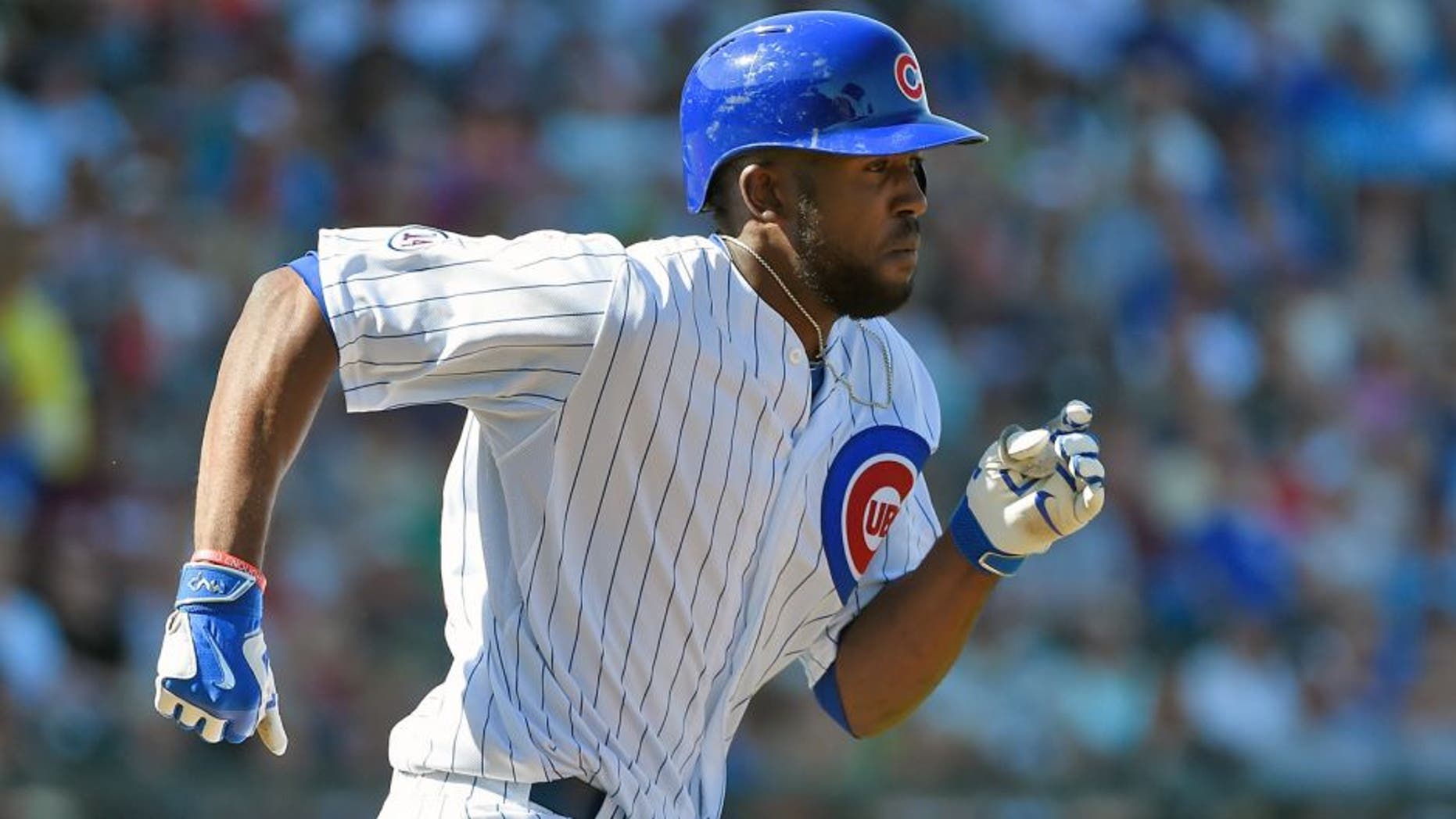 MESA, AZ - MARCH 09: Dexter Fowler #24 of the Chicago Cubs runs to first base after hitting a single against the San Diego Padres on March 9, 2015 in Mesa, Arizona. (Photo by Lisa Blumenfeld/Getty Images)