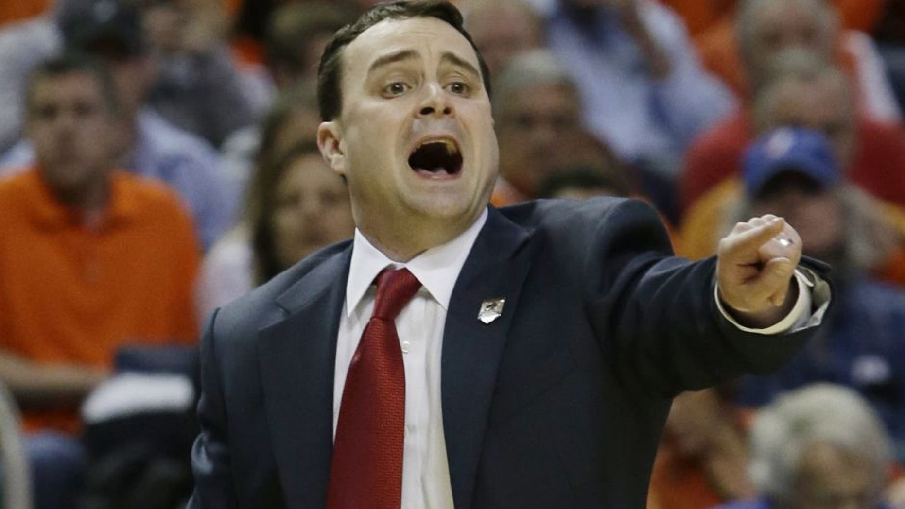 Dayton coach Archie Miller calls out to his team during the first half of a third-round game against Syracuse in the NCAA men's college basketball tournament in Buffalo, N.Y., Saturday, March 22, 2014. (AP Photo/Nick LoVerde)