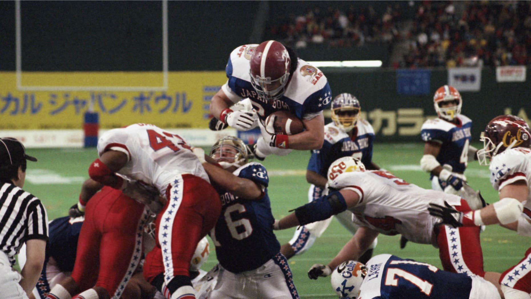 FILE - In this Jan. 12, 1992 file photo, East’s Kevin Turner, of Alabama, dives over the top for a touchdown in the fourth quarter of the Japan Bowl, the American collegiate all-star football game, at the Tokyo Dome.