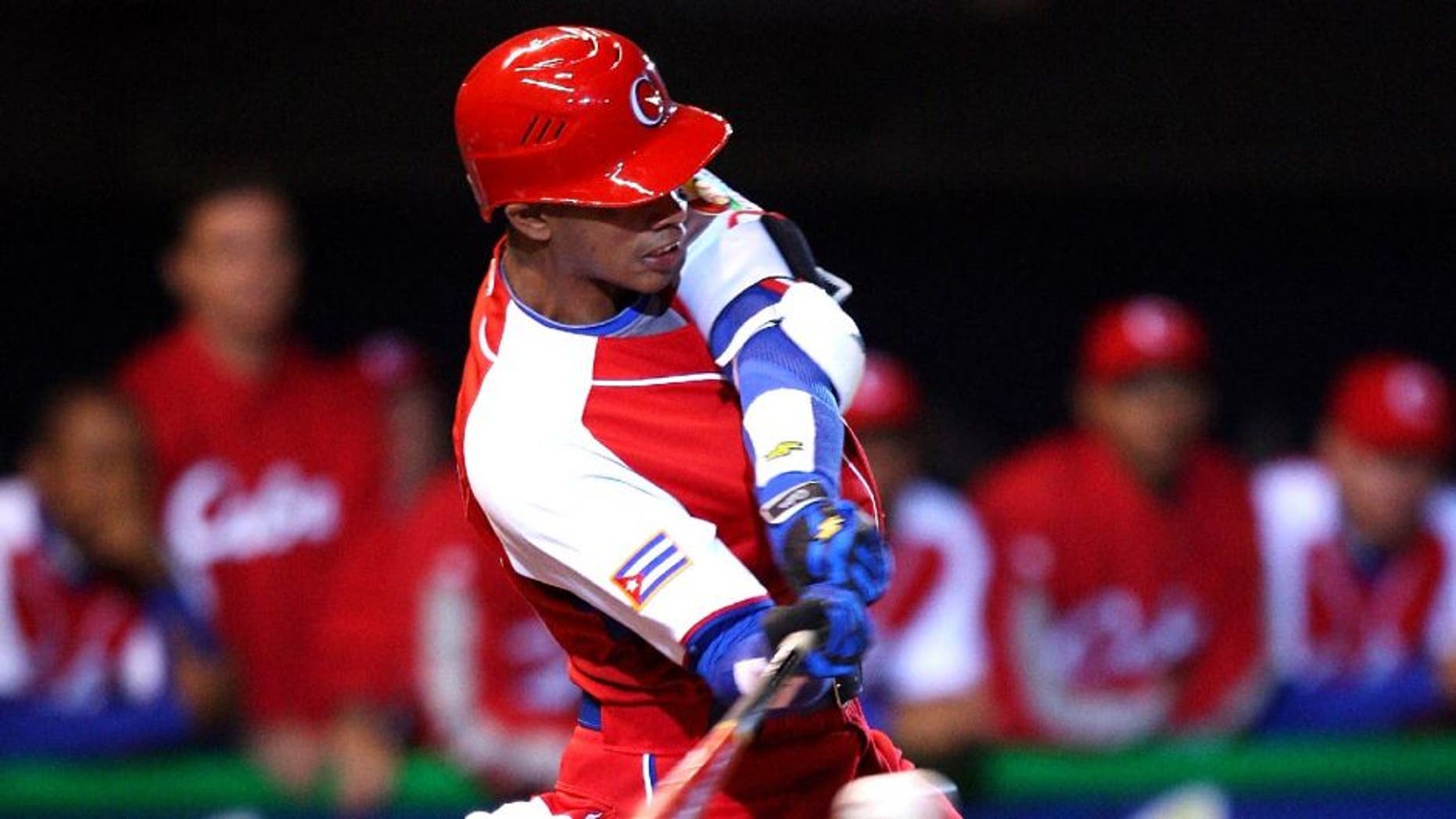 MEXICO CITY - MARCH 10: Second baseman Hector Olivera #28 of Cuba blasts a line drive for an out during the Pool B, game four against Australia in the first round of the 2009 World Baseball Classic at Foro Sol Stadium in Mexico City, Mexico, Monday March 10, 2009. Cuba defeated Australia 5-4. (Photo by Paul Spinelli/WBCI/MLB Photos via Getty Images)