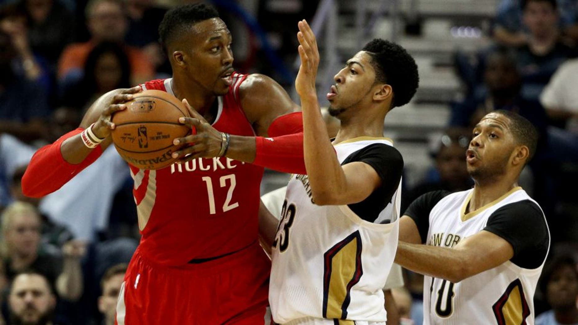Mar 25, 2015; New Orleans, LA, USA; Houston Rockets center Dwight Howard (12) is defended by New Orleans Pelicans forward Anthony Davis (23) during the second half of a game at the Smoothie King Center. The Rockets defeated the Pelicans 95-93. Mandatory Credit: Derick E. Hingle-USA TODAY Sports