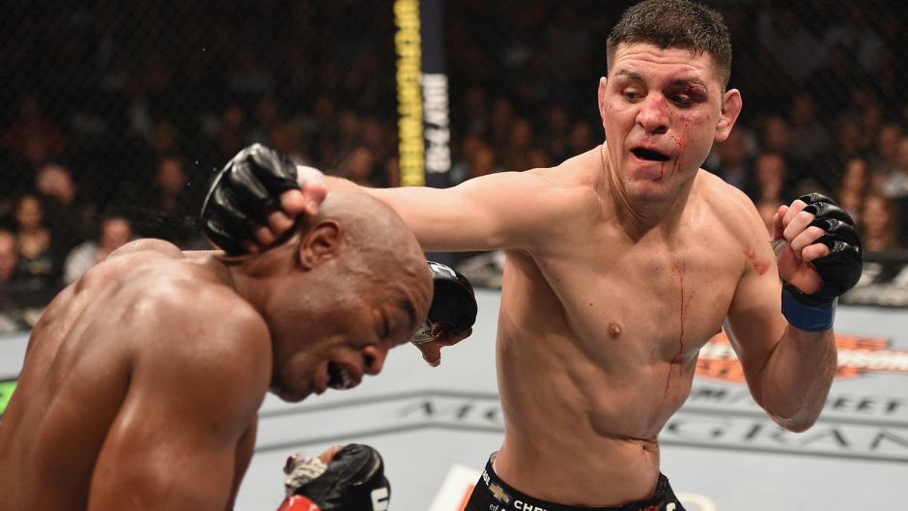 LAS VEGAS, NV - JANUARY 31: (R-L) Nick Diaz punches Anderson Silva of Brazil in their middleweight bout during the UFC 183 event at the MGM Grand Garden Arena on January 31, 2015 in Las Vegas, Nevada. (Photo by Josh Hedges/Zuffa LLC/Zuffa LLC via Getty Images)