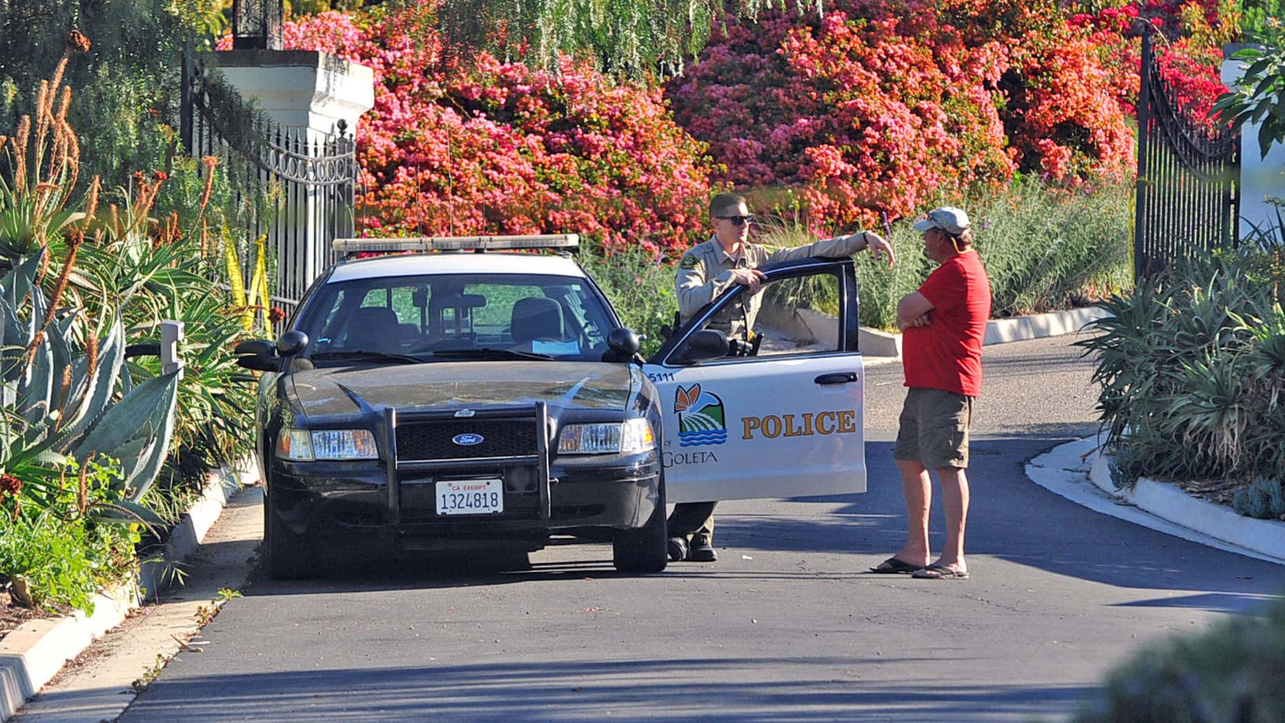 March 24, 2016: A Goleta Police officer stands guard near a home on Greenhill Way in unincorporated county territory between Santa Barbara and Goleta, Calif.