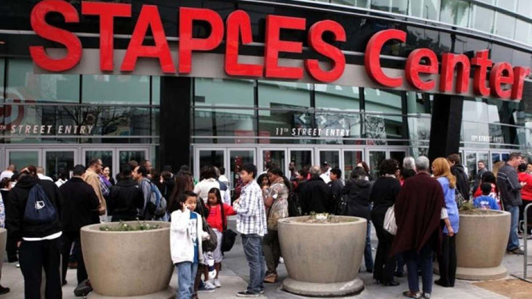 Basketball fans wait outside Staples Center before an NBA basketball game between Los Angeles Clippers and the Cleveland Cavaliers in Los Angeles, Saturday, March 19, 2011.