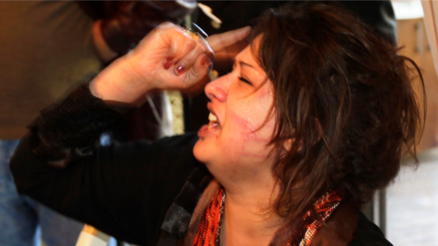 March 26: Iman Al-Obeidi, who said she spent two days in detention after being arrested at a checkpoint in Tripoli, Libya, and sexually assaulted by up to 15 men while in custody shouts to tell her story at the Rixos hotel in Tripoli after storming into the hotel's breakfast room to show her wounds to foreign media.