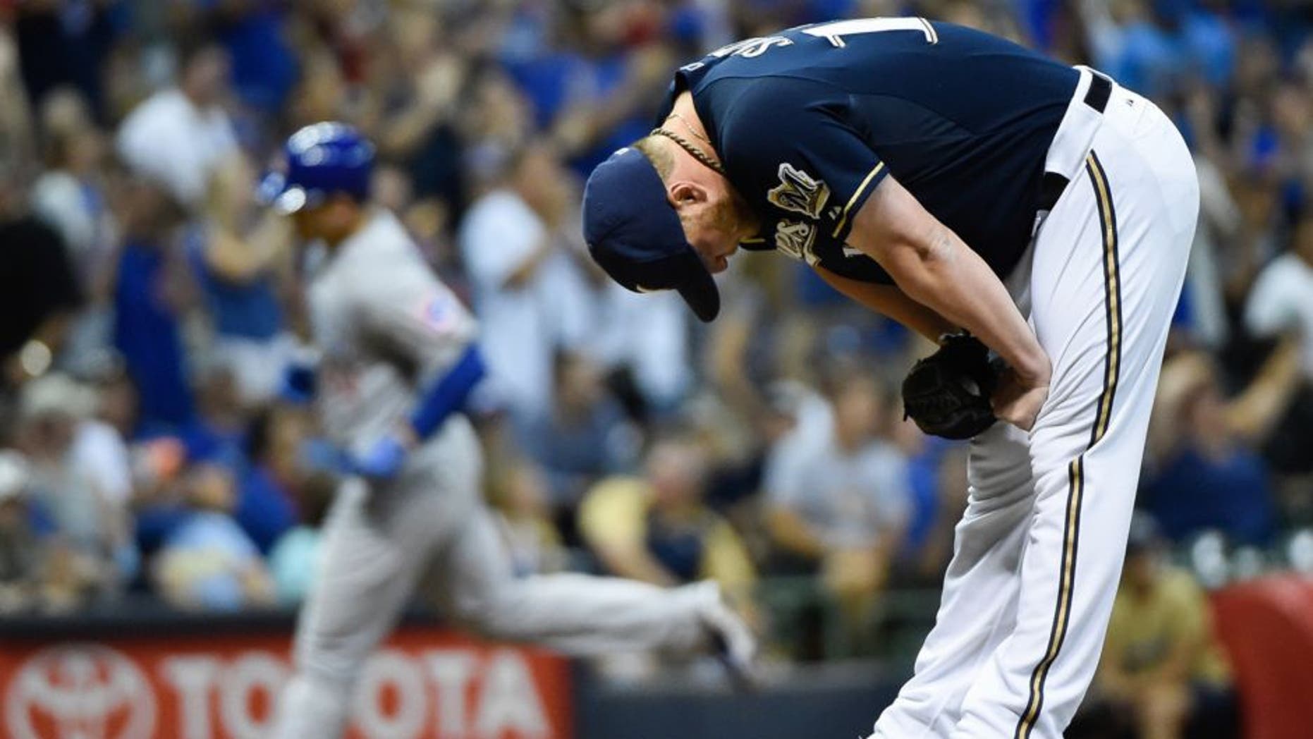 Jul 30, 2015; Milwaukee, WI, USA; Milwaukee Brewers pitcher Will Smith (13) reacts after giving up a 3-run homer to Chicago Cubs first baseman Anthony Rizzo (44) in the eighth inning at Miller Park. Smith was charged with the loss as The Cubs won 5-2. Mandatory Credit: Benny Sieu-USA TODAY Sports