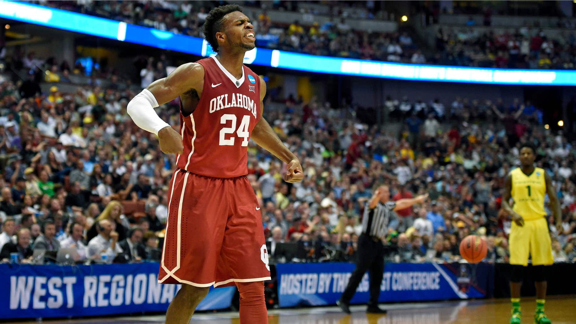 Oklahoma guard Buddy Hield celebrates after scoring during the first half of an NCAA college basketball game against Oregon in the regional finals of the NCAA Tournament, Saturday, March 26, 2016, in Anaheim, Calif.