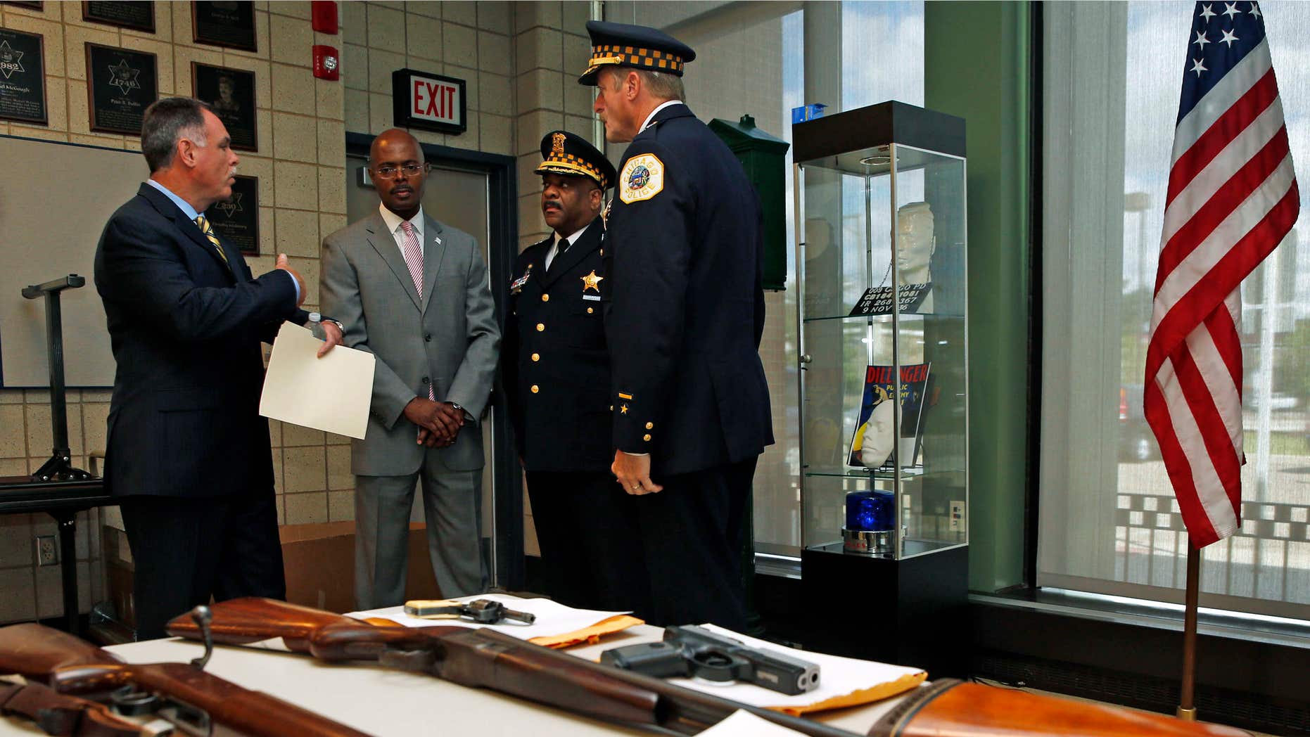 Sept. 3, 2013: Chicago Police Superintendent Garry McCarthy (L) speaks to First Deputy Superintendent Al Wysinger (2nd L), Deputy Chief of Area Central Patrol Eddie Johnson (2nd R) and Bureau of Patrol Chief Wayne Gulliford after a news conference on Chicago Police having seized more than 4,800 illegal firearms in 2013 in Chicago, Illinois,