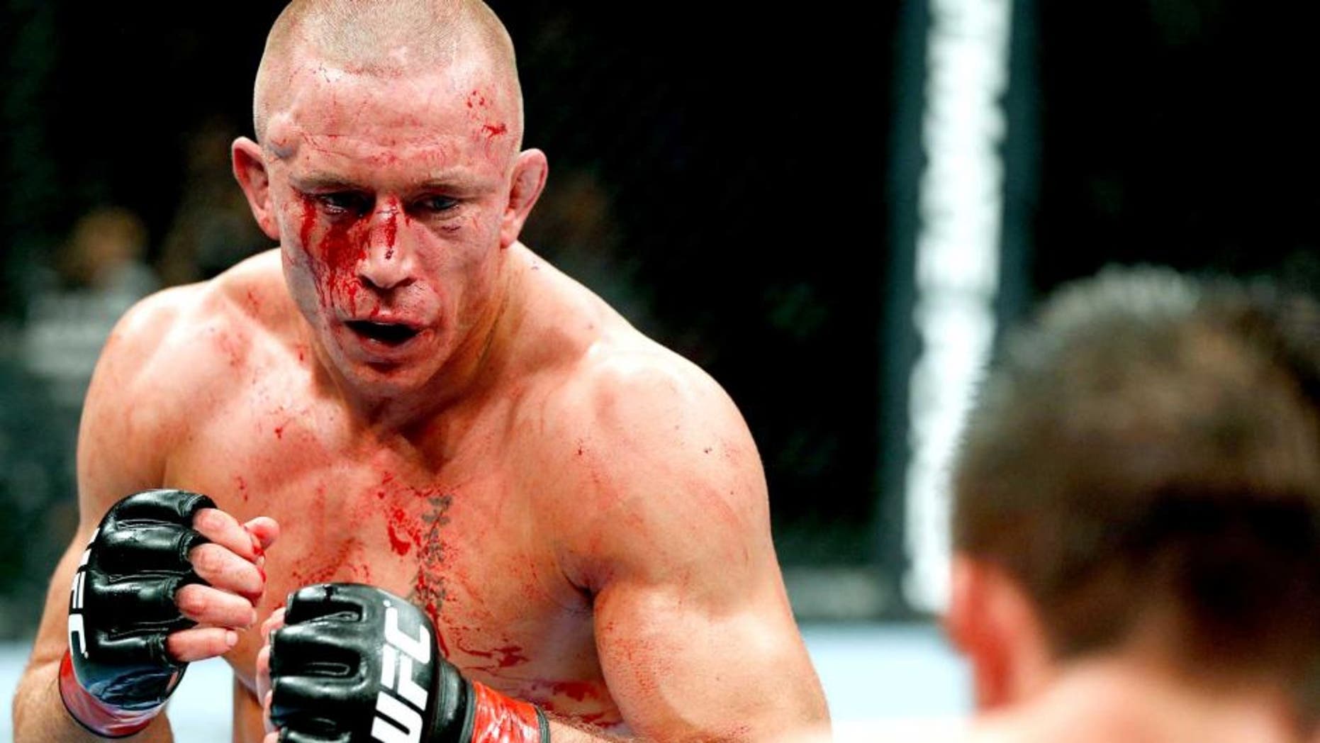 MONTREAL, QC - NOVEMBER 17: Georges St-Pierre (L) fights against Carlos Condit in their welterweight title bout during UFC 154 on November 17, 2012 at the Bell Centre in Montreal, Canada. (Photo by Josh Hedges/Zuffa LLC/Zuffa LLC via Getty Images)