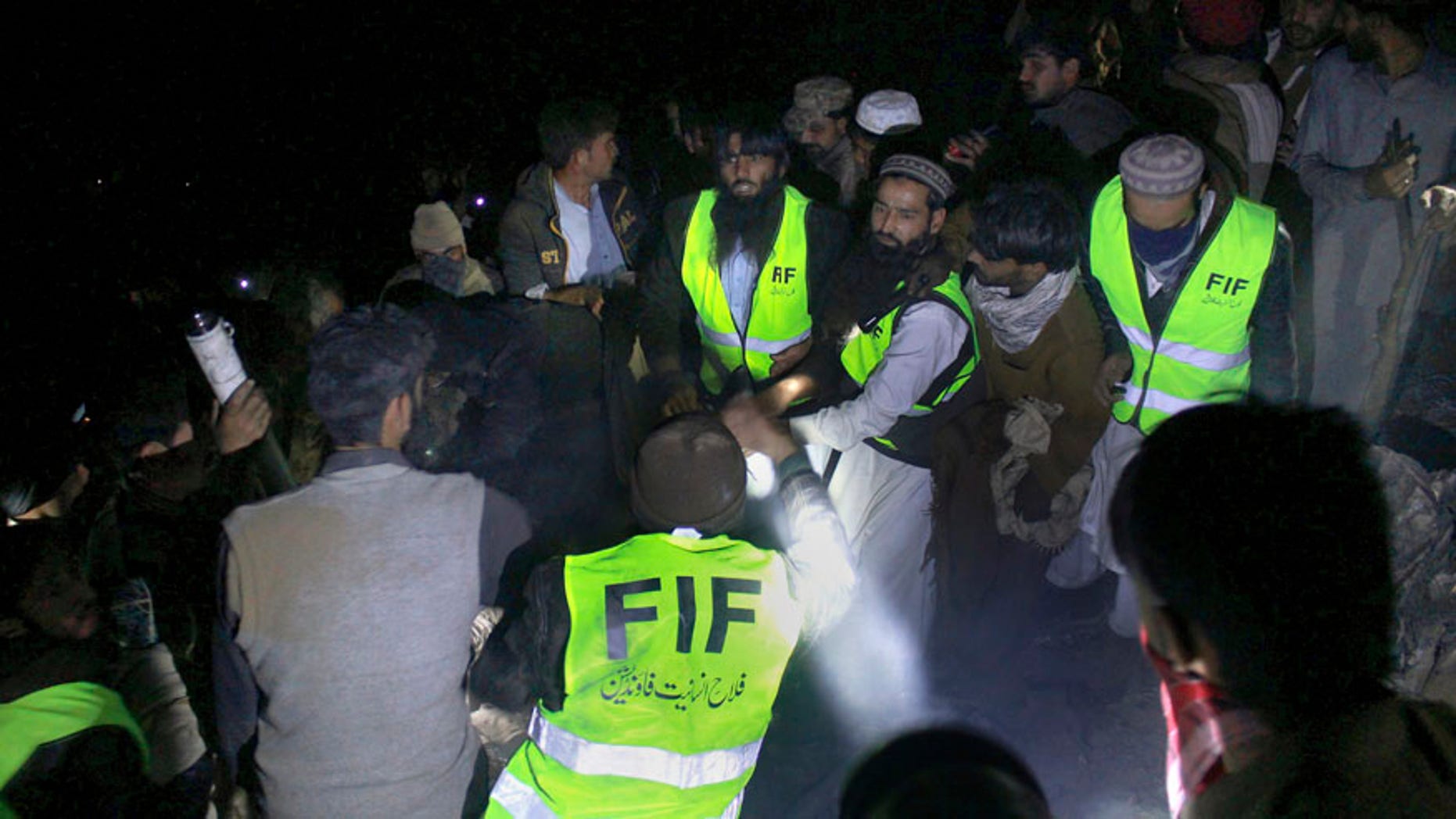 Pakistan army troops and rescue workers collect remains of victims at the site of a plane crash, in a village near the town of Havelian, about 75 kilometers (45 miles) northwest of the capital, Islamabad, Pakistan, Wednesday, Dec. 7, 2016.